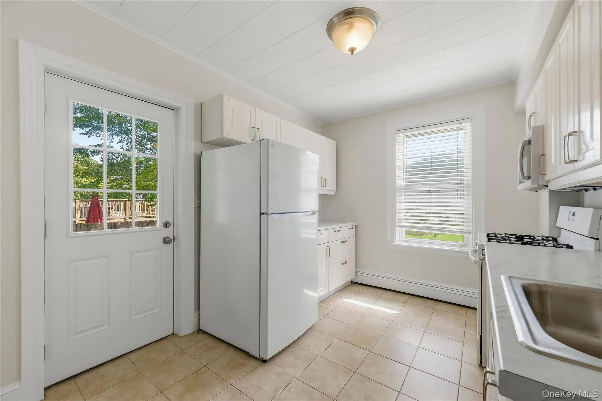 Kitchen with a door leading out to your private porch and shared back yard. Kitchen with a door leading out to your private porch and shared back yard.