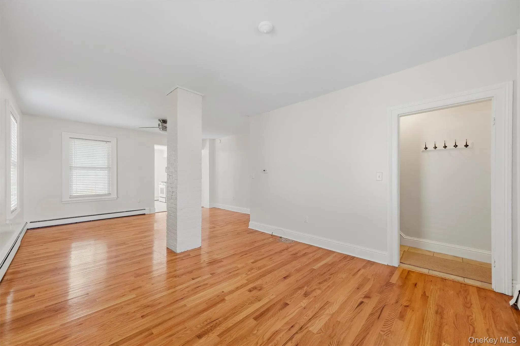 Hardwood flooring throughout, white painted walls, and white trim Hardwood flooring throughout, white painted walls, and white trim