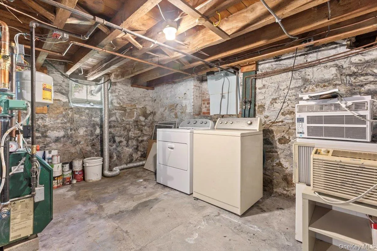 Unfinished basement with washing machine and dryer Unfinished basement with washing machine and dryer