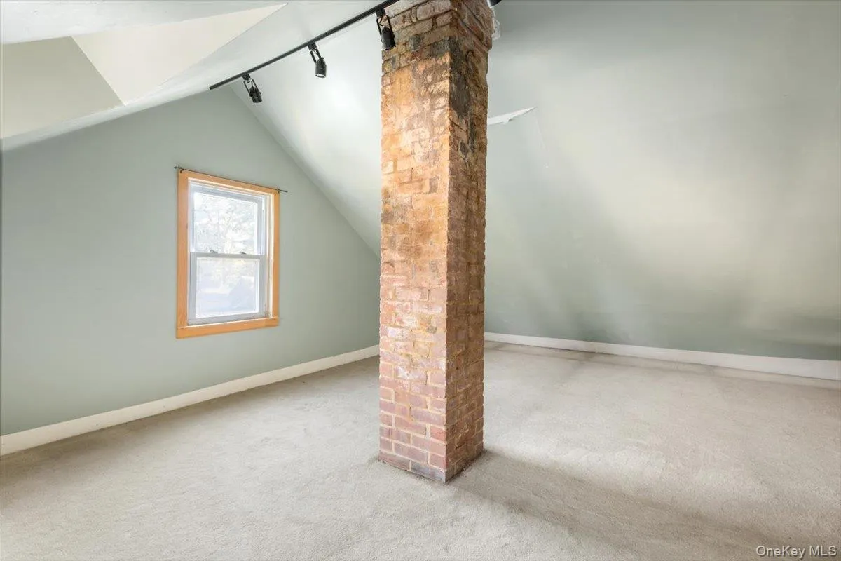 Additional living space featuring carpet flooring, lofted ceiling, and baseboards Additional living space featuring carpet flooring, lofted ceiling, and baseboards