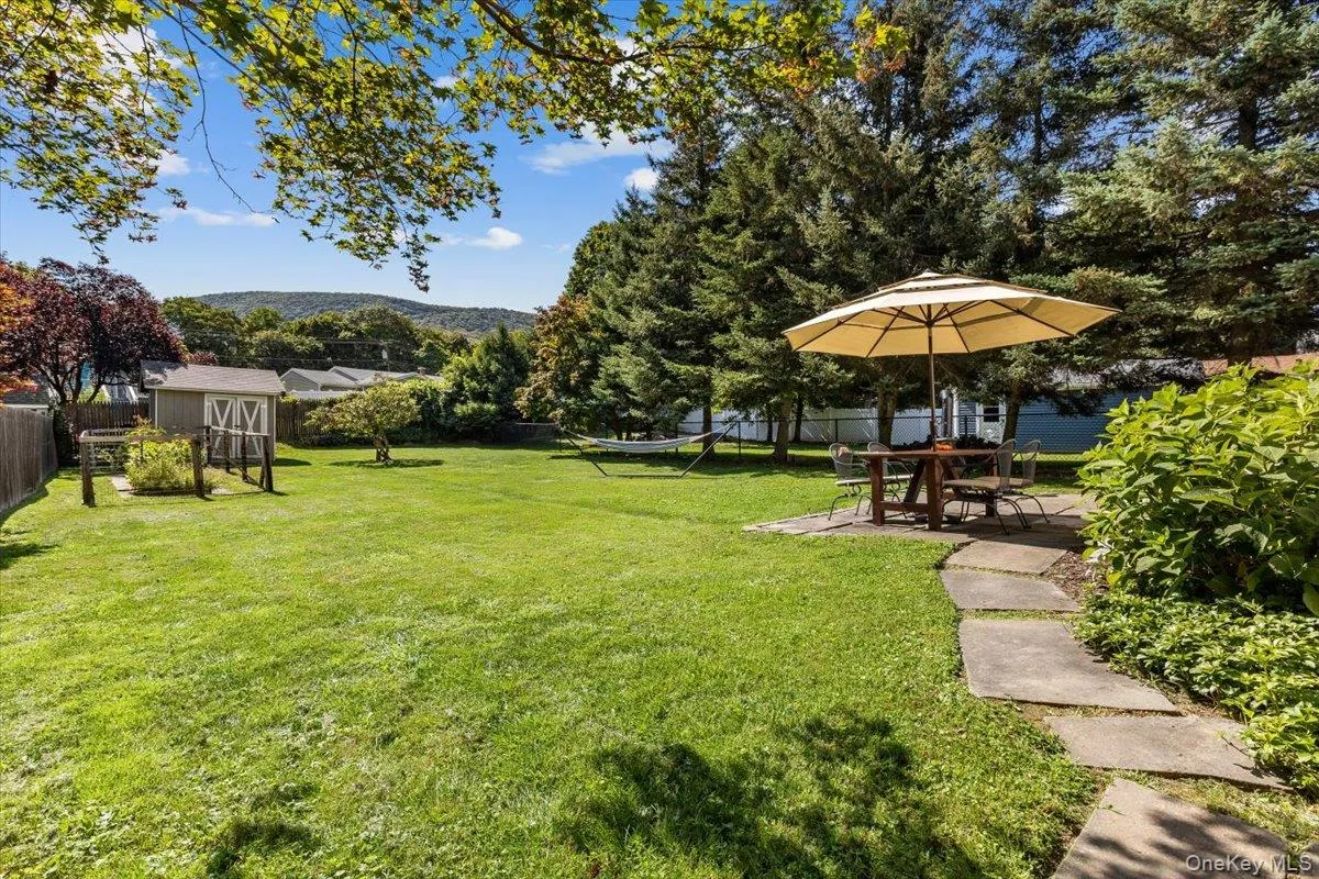 View of yard featuring a patio, a fenced backyard, an outbuilding, and a storage shed View of yard featuring a patio, a fenced backyard, an outbuilding, and a storage shed