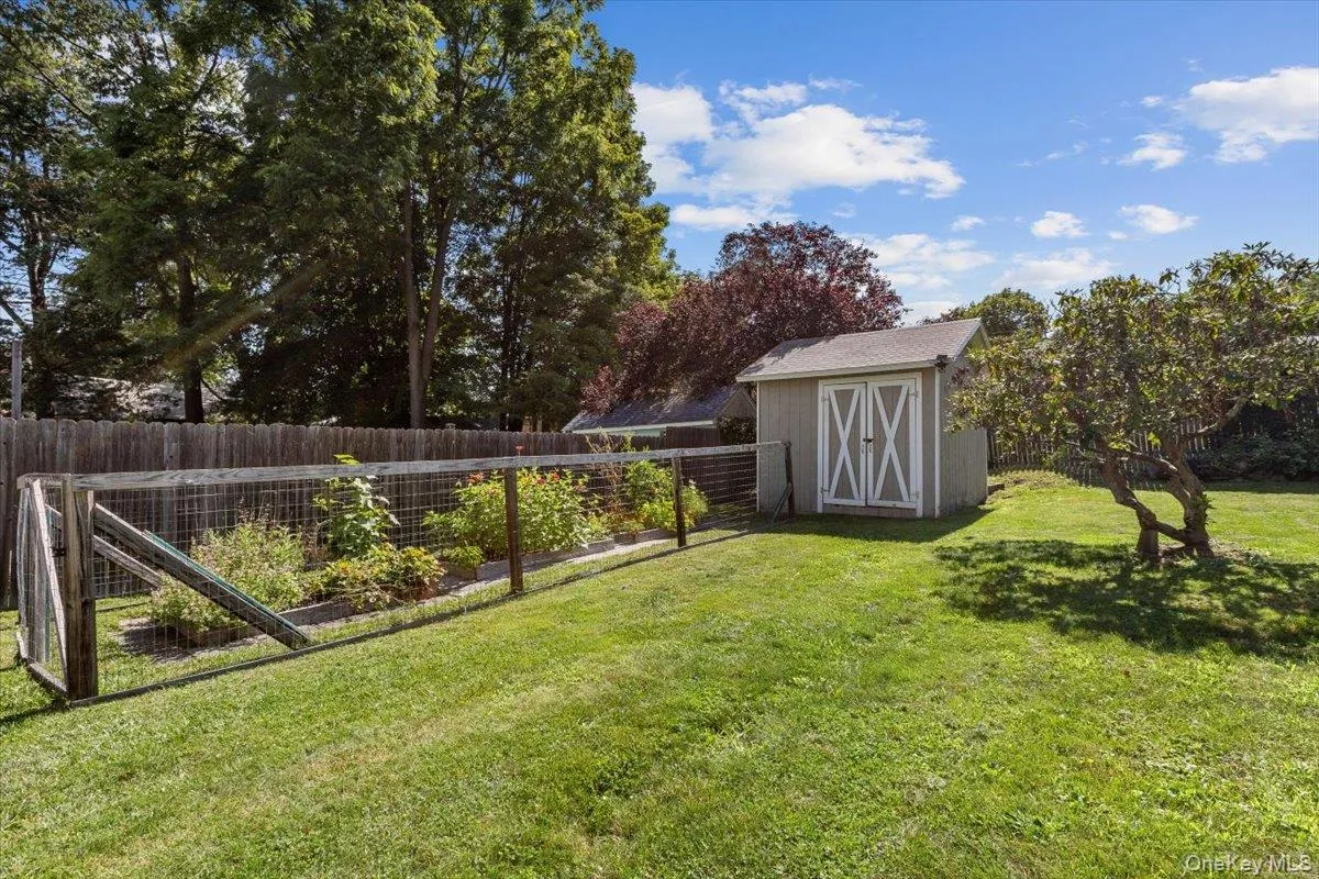 View of yard with a storage shed, a vegetable garden, an outbuilding, and a fenced backyard View of yard with a storage shed, a vegetable garden, an outbuilding, and a fenced backyard