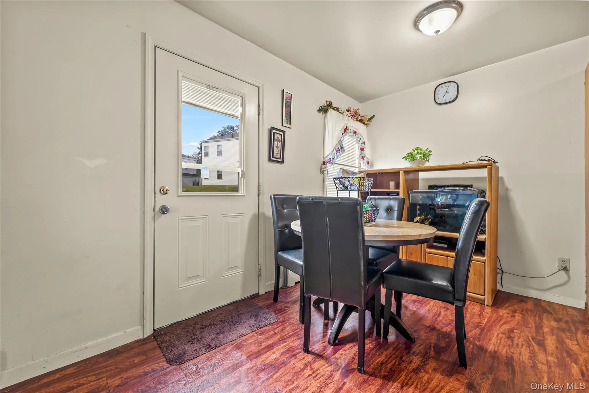 Dining space with baseboards and wood finished floors Dining space with baseboards and wood finished floors