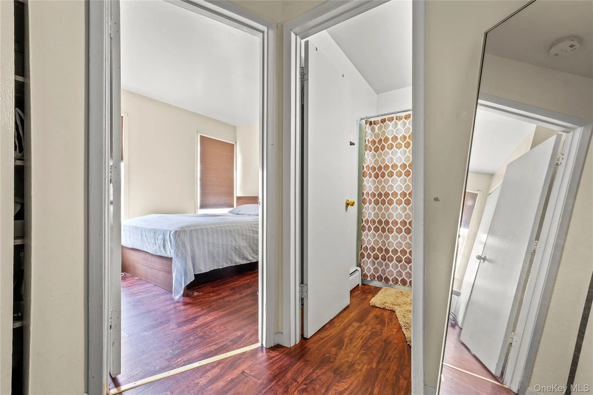 Corridor featuring dark wood-style floors Corridor featuring dark wood-style floors