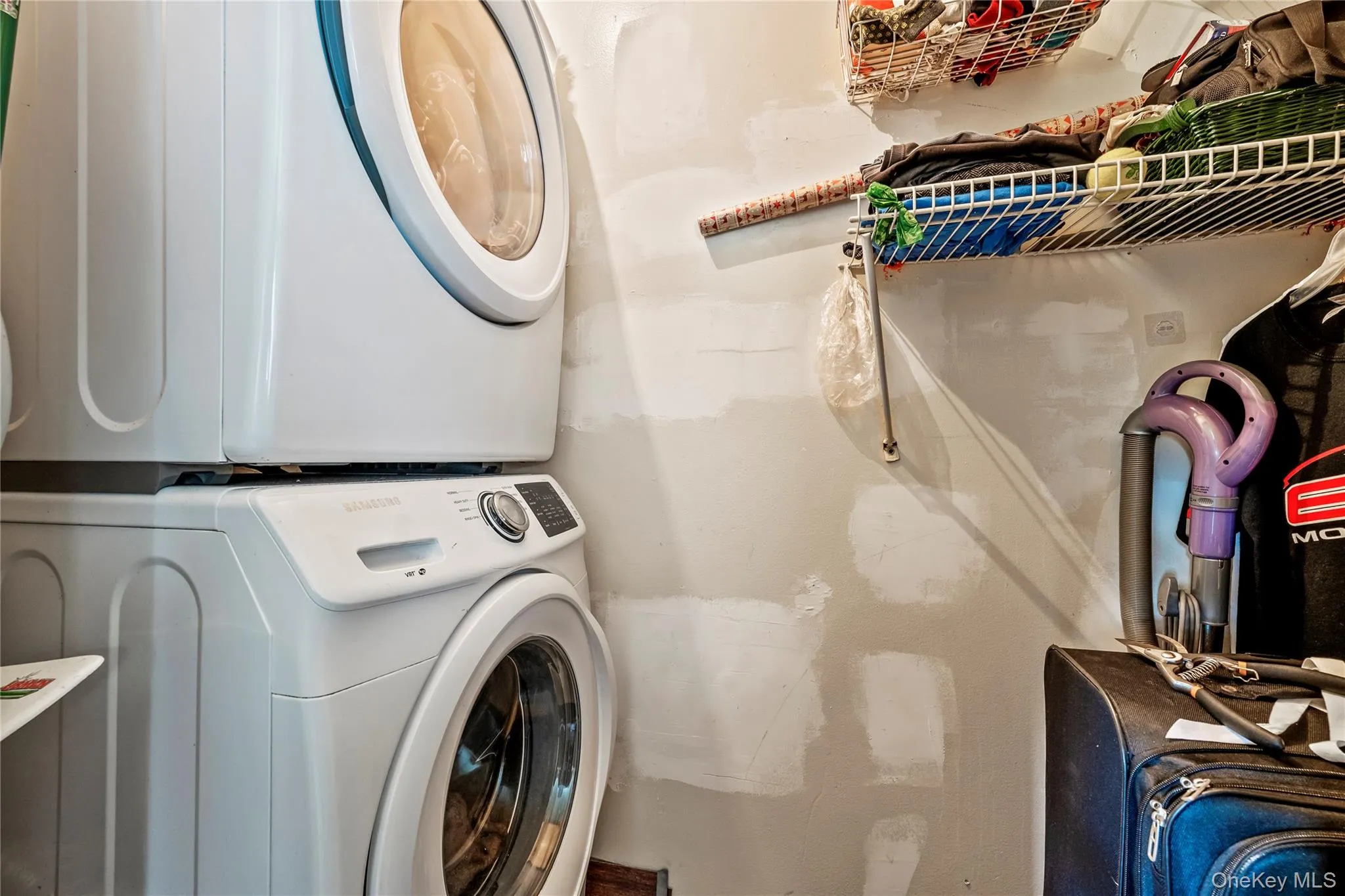 Laundry room with stacked washing machine and dryer Laundry room with stacked washing machine and dryer