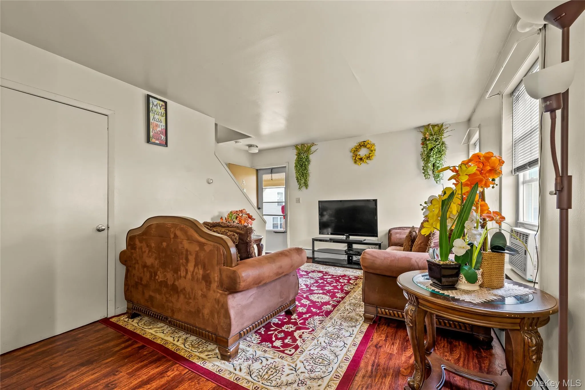 Living room with wood finished floors and healthy amount of natural light Living room with wood finished floors and healthy amount of natural light