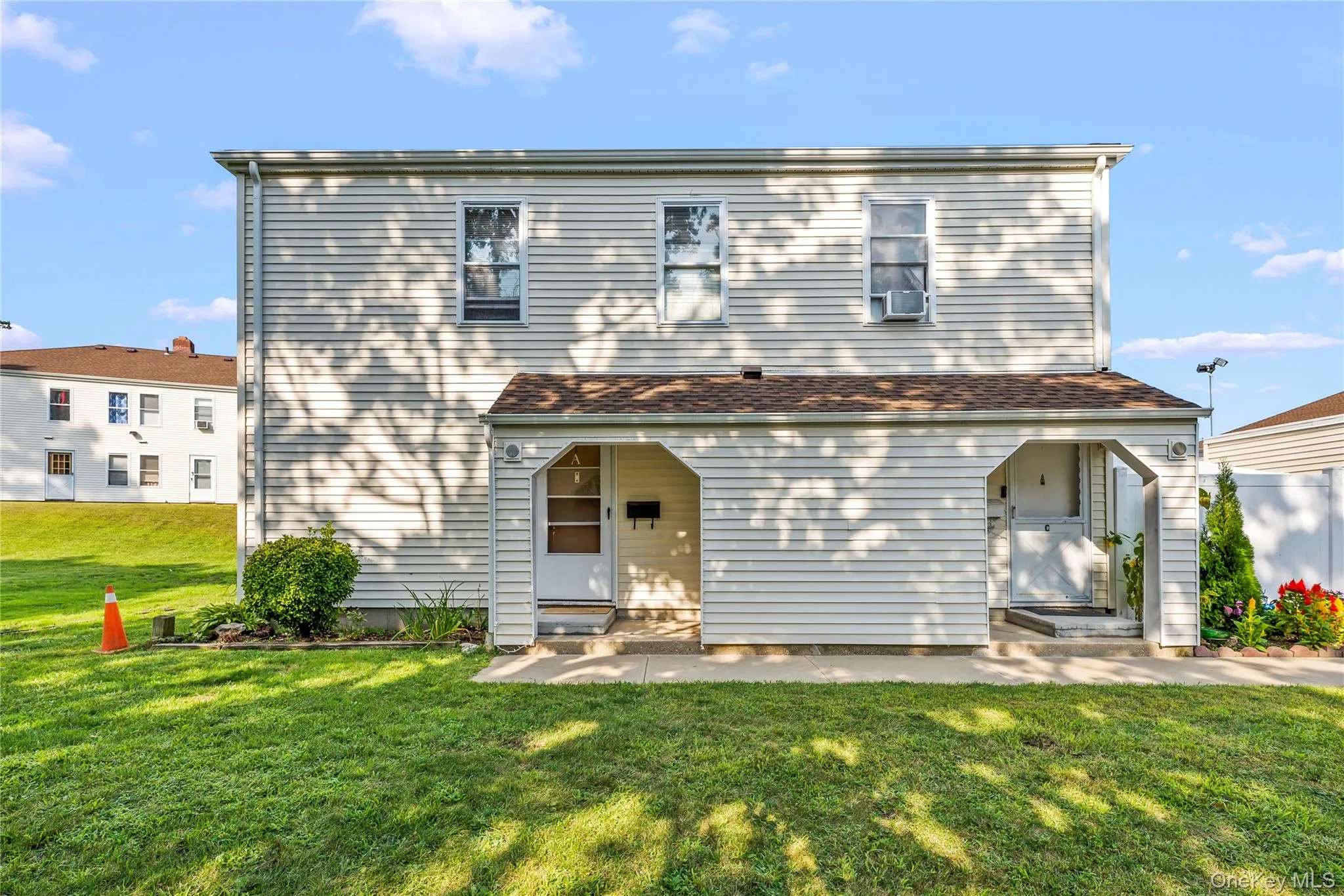 Front of property featuring a lawn and entry steps Front of property featuring a lawn and entry steps