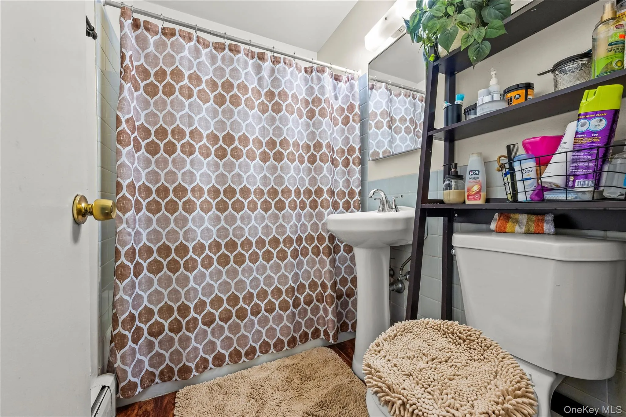 Full bath with baseboard heating and toilet Full bath with baseboard heating and toilet