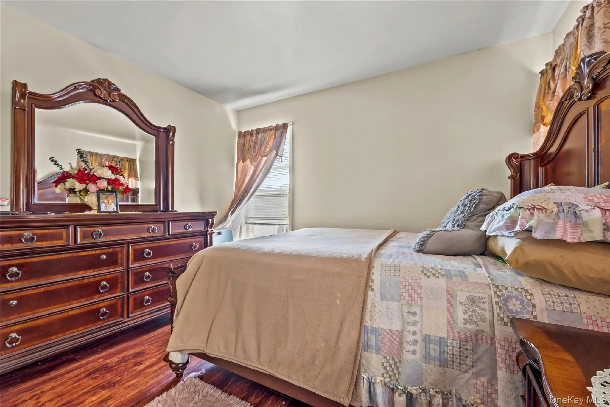 Bedroom featuring wood finished floors Bedroom featuring wood finished floors