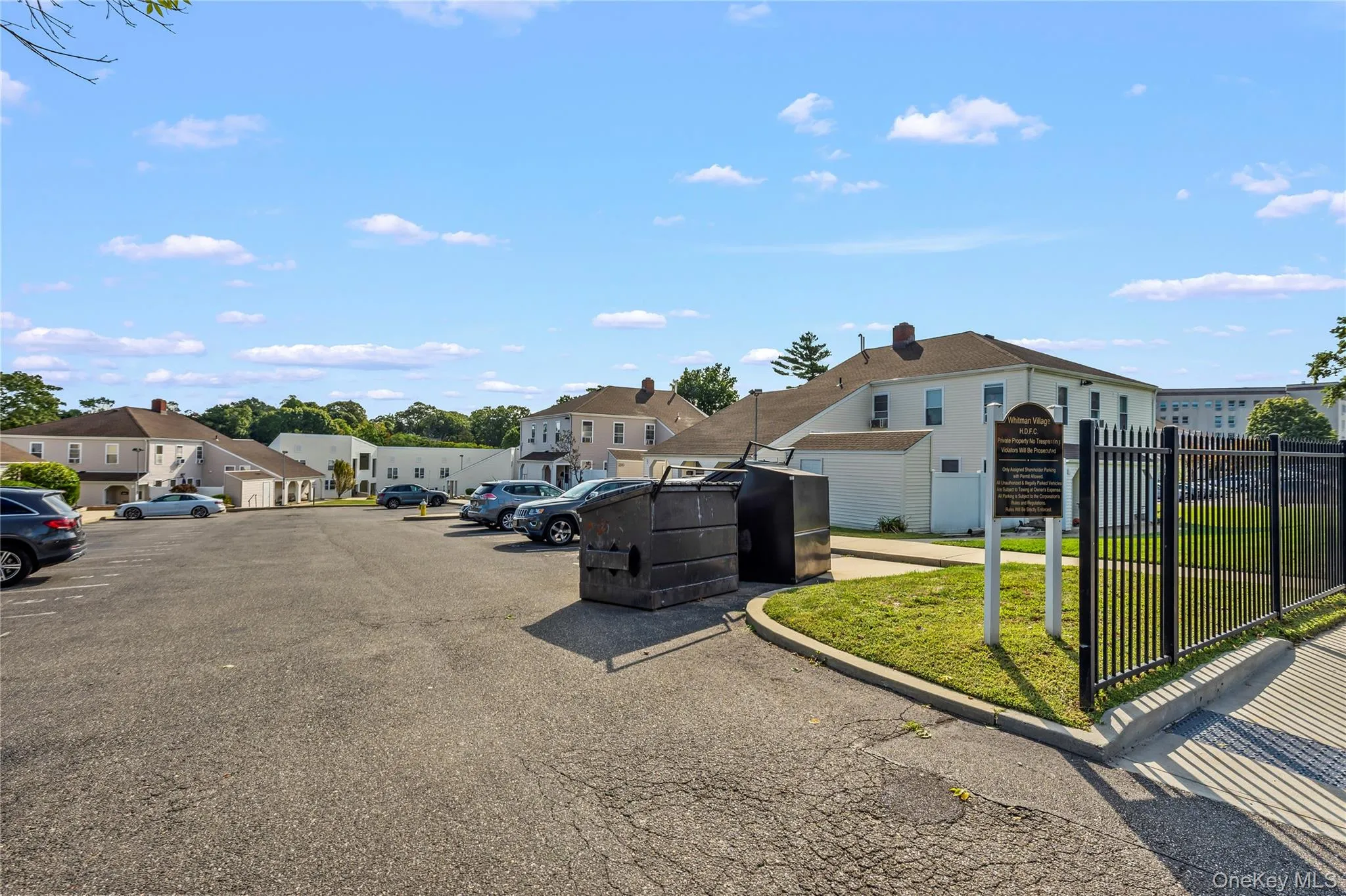 Uncovered parking lot featuring a residential view Uncovered parking lot featuring a residential view