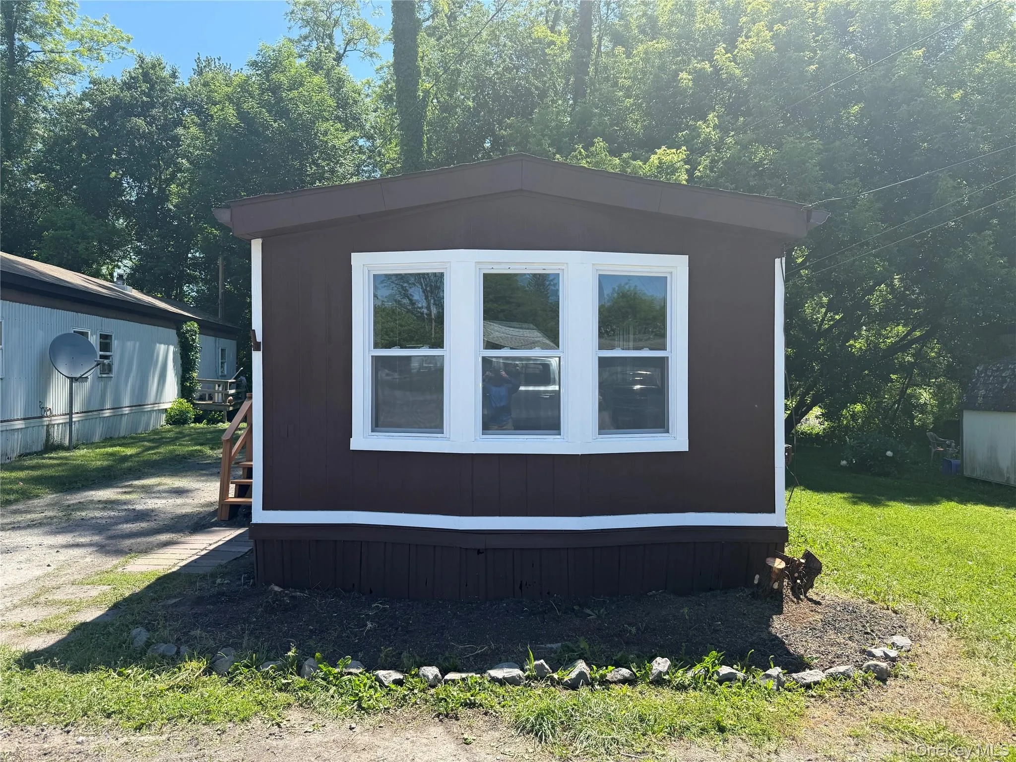 Front exterior view with white-trimmed windows Front exterior view with white-trimmed windows