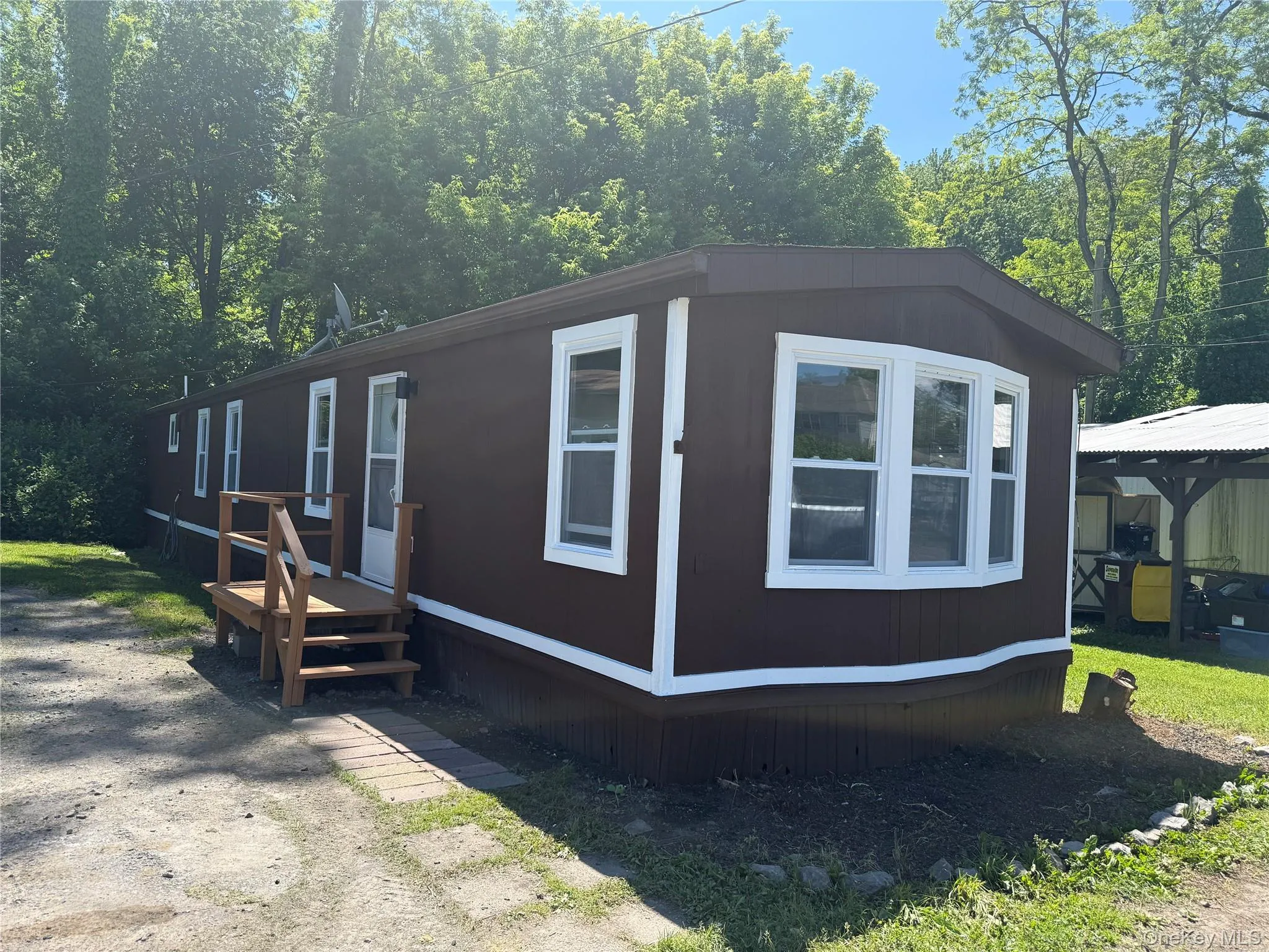 Brown exterior siding with white trim and multiple windows Brown exterior siding with white trim and multiple windows