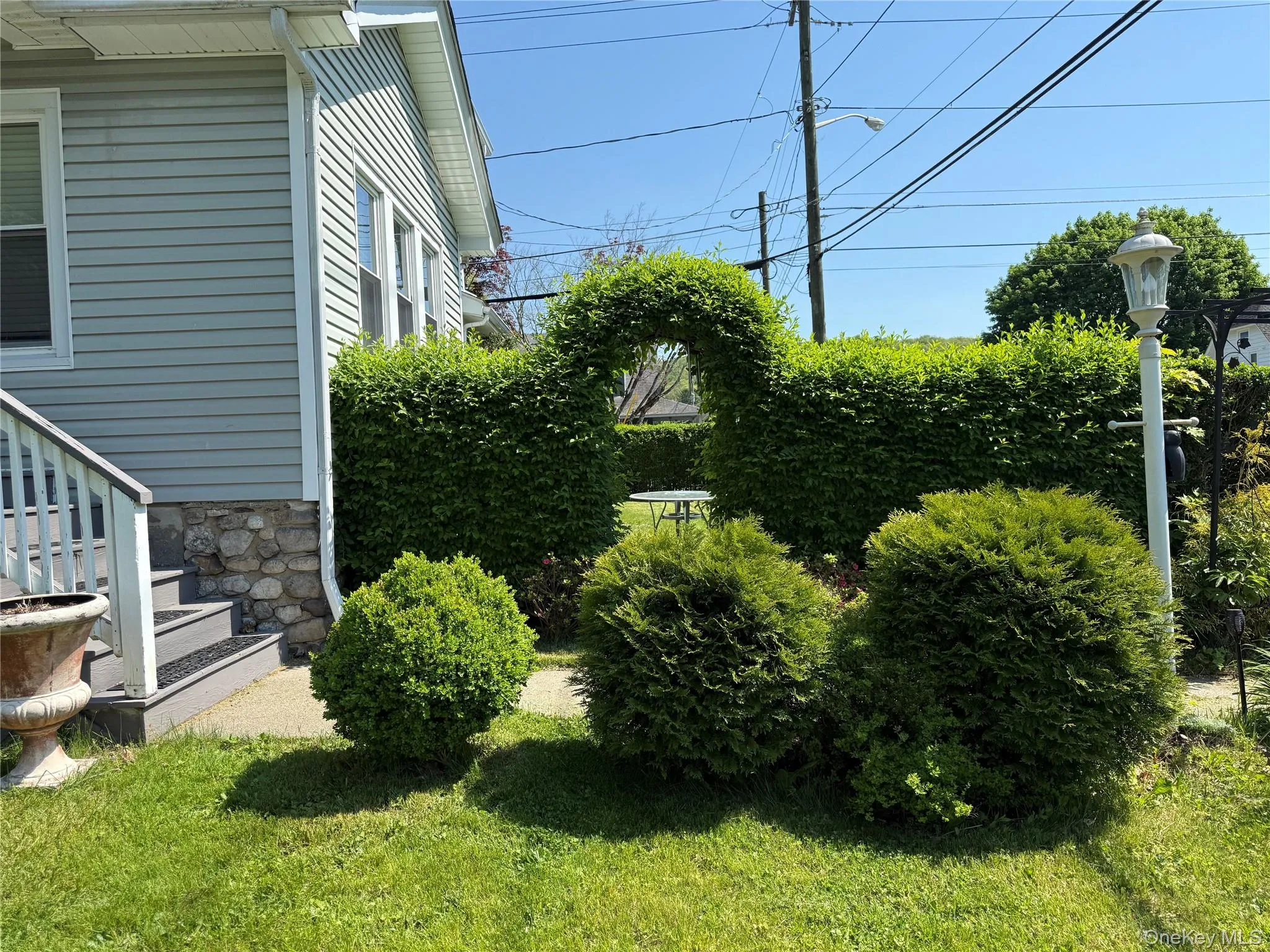 Beautifully landscaped yard with mature shrubs and outdoor enjoyment space. Beautifully landscaped yard with mature shrubs and outdoor enjoyment space.