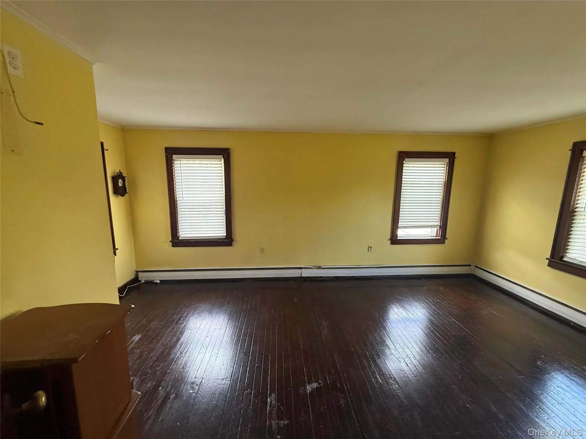 Comfortable bedroom featuring natural light and hardwood flooring. Comfortable bedroom featuring natural light and hardwood flooring.