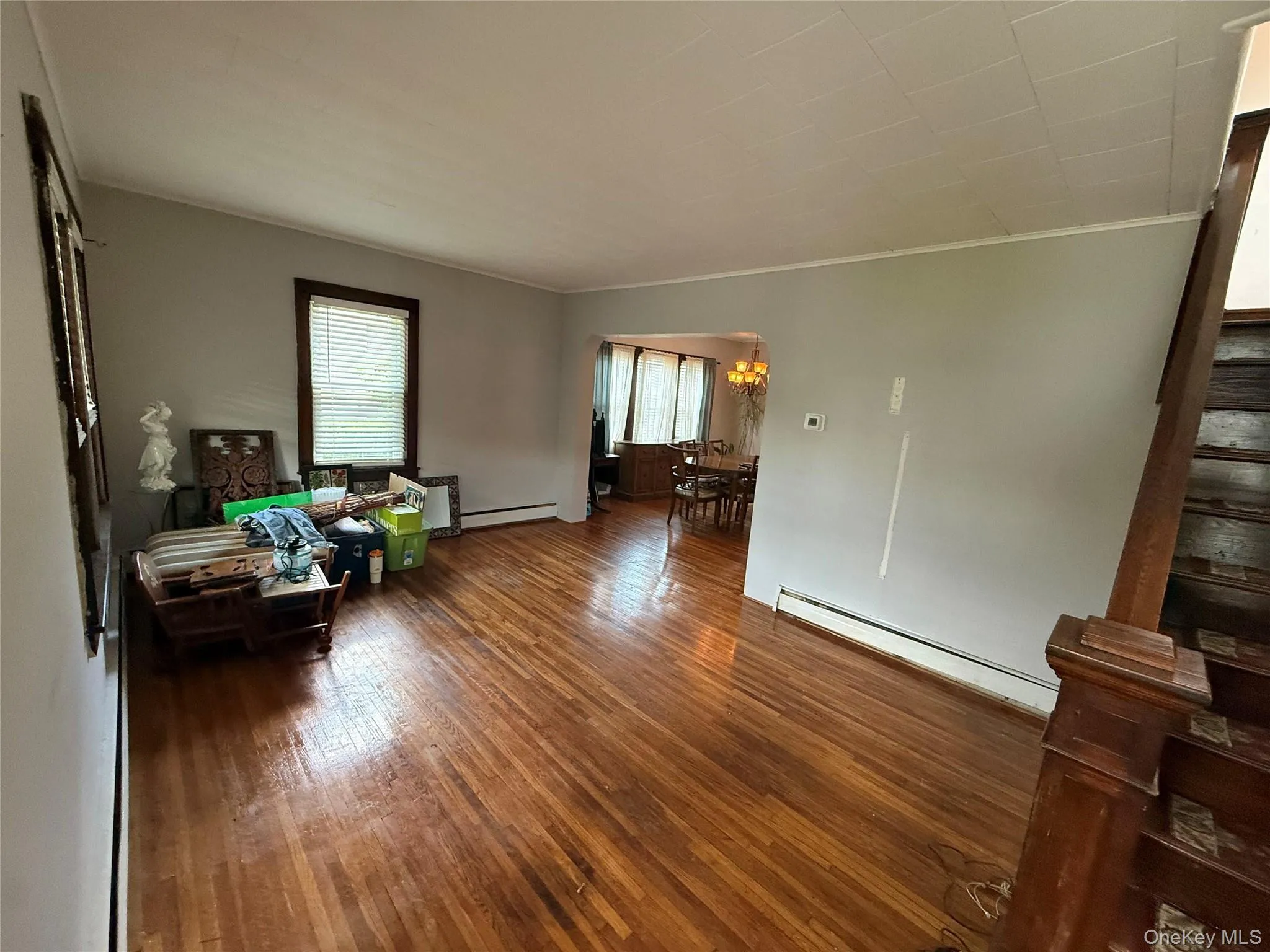 Bright and spacious living room featuring hardwood floors and abundant natural light Bright and spacious living room featuring hardwood floors and abundant natural light