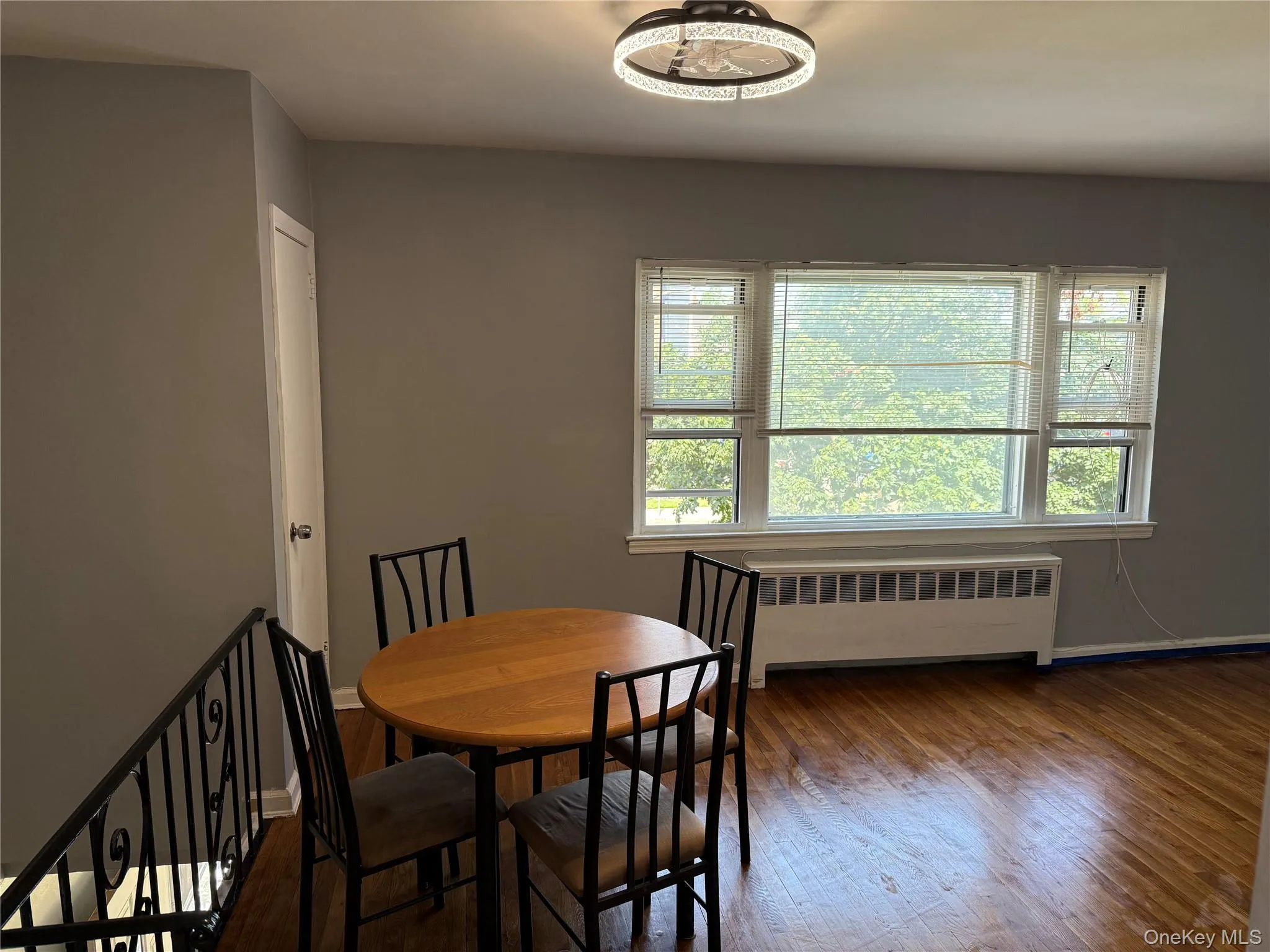 Dining space featuring radiator and wood finished floors Dining space featuring radiator and wood finished floors