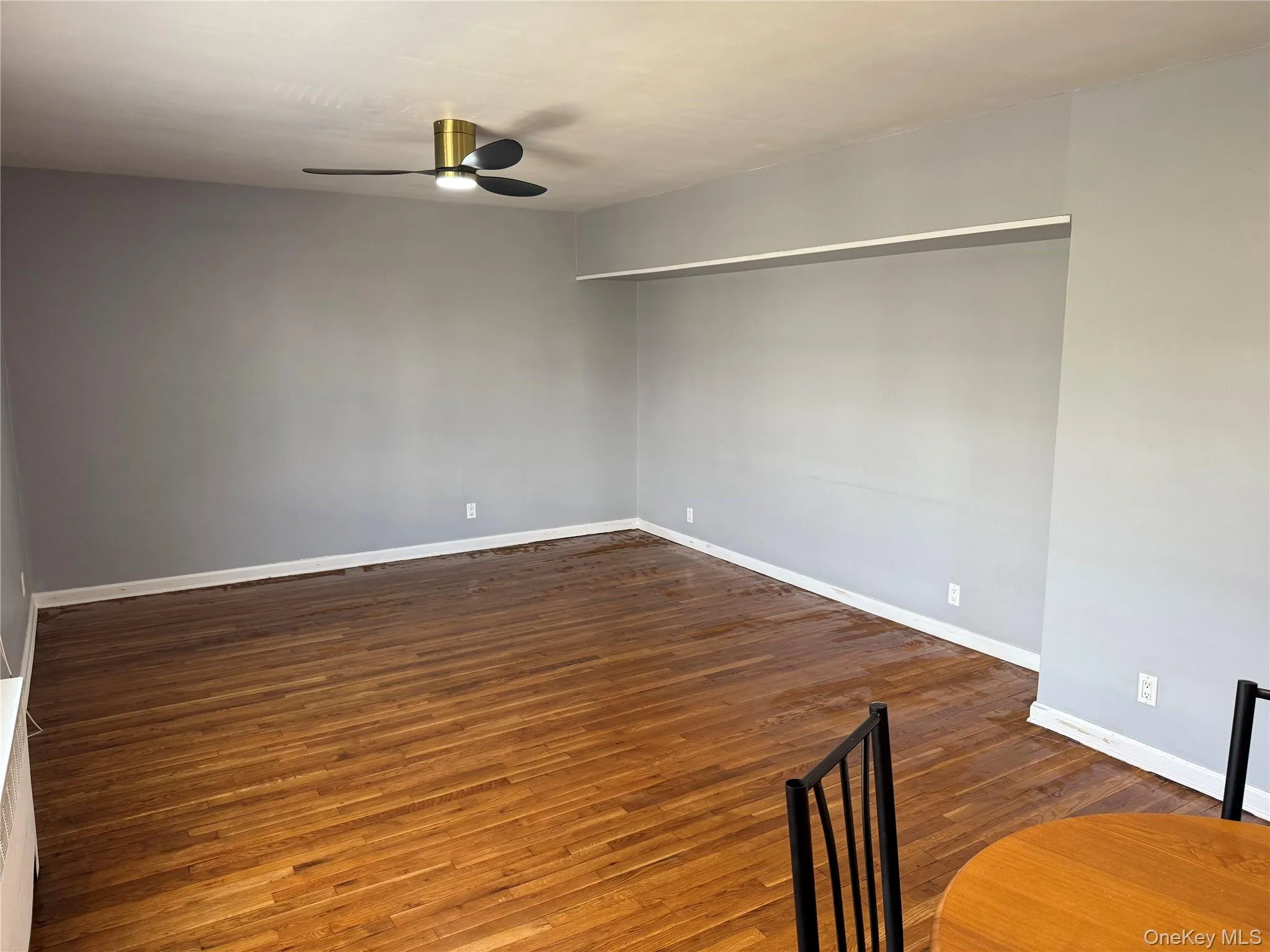 Unfurnished room featuring ceiling fan and wood finished floors Unfurnished room featuring ceiling fan and wood finished floors