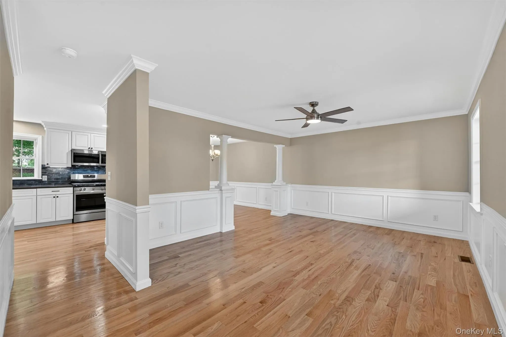 Hardwood flooring complemented by wainscoting and crown molding Hardwood flooring complemented by wainscoting and crown molding