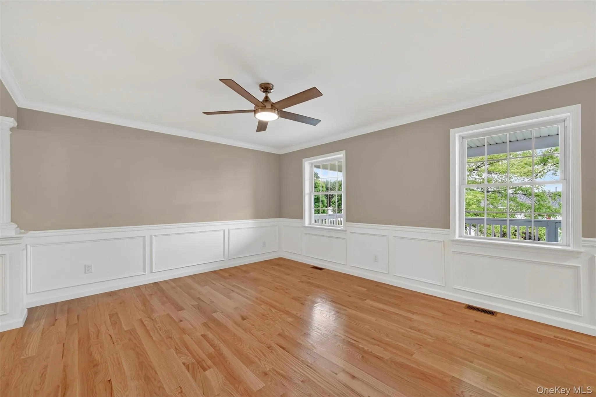 Hardwood flooring complemented by wainscoting and crown molding Hardwood flooring complemented by wainscoting and crown molding