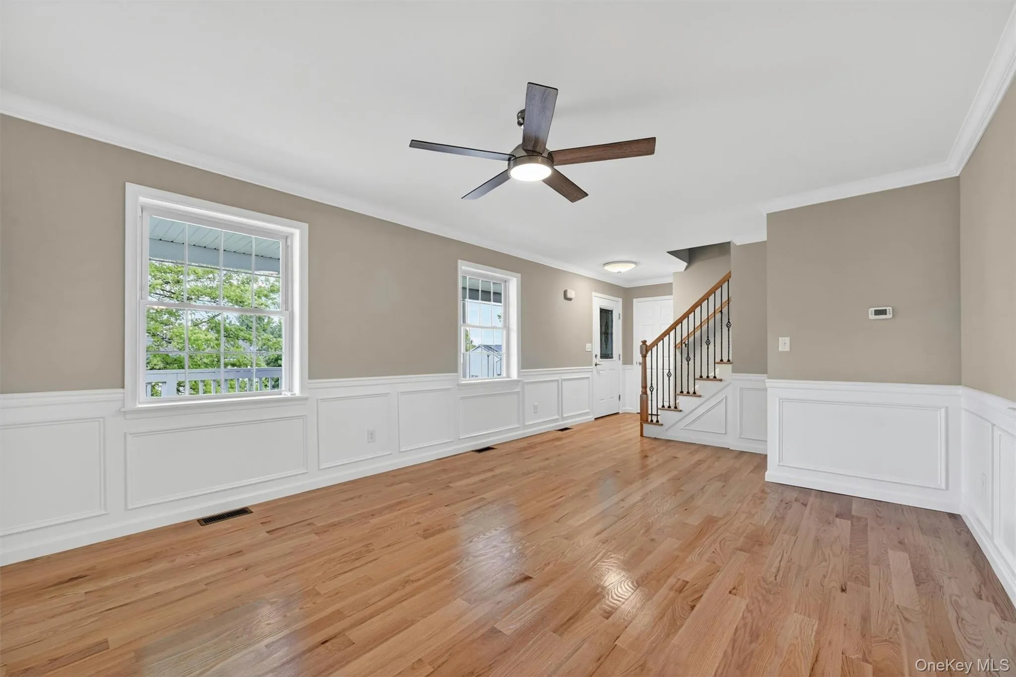Hardwood flooring complemented by wainscoting and crown molding Hardwood flooring complemented by wainscoting and crown molding
