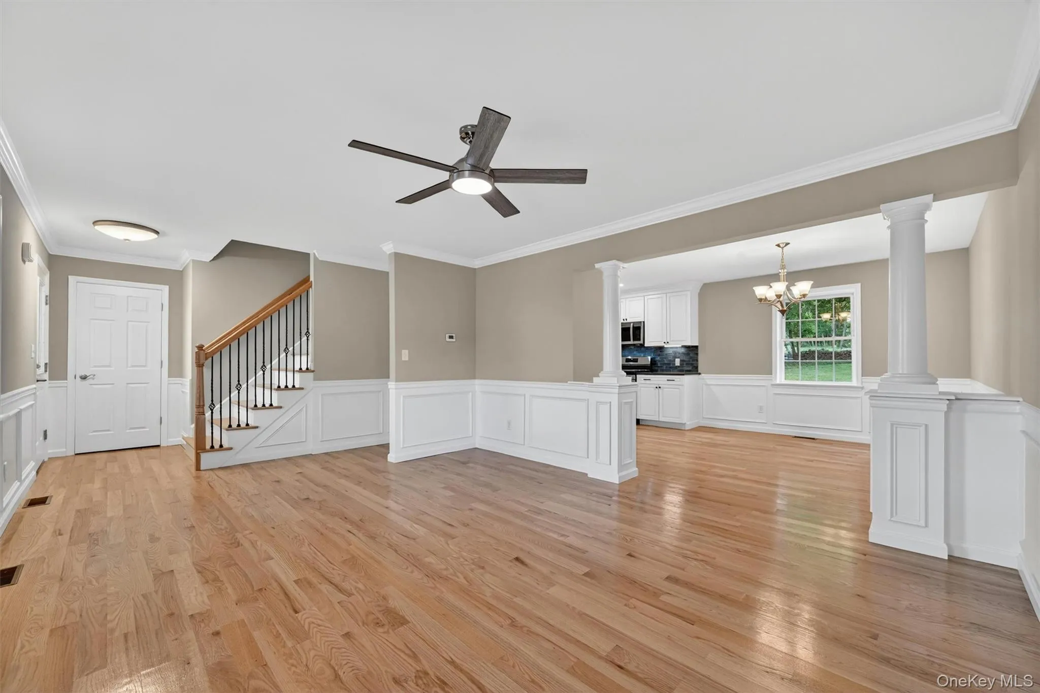 Hardwood flooring complemented by wainscoting and crown molding Hardwood flooring complemented by wainscoting and crown molding