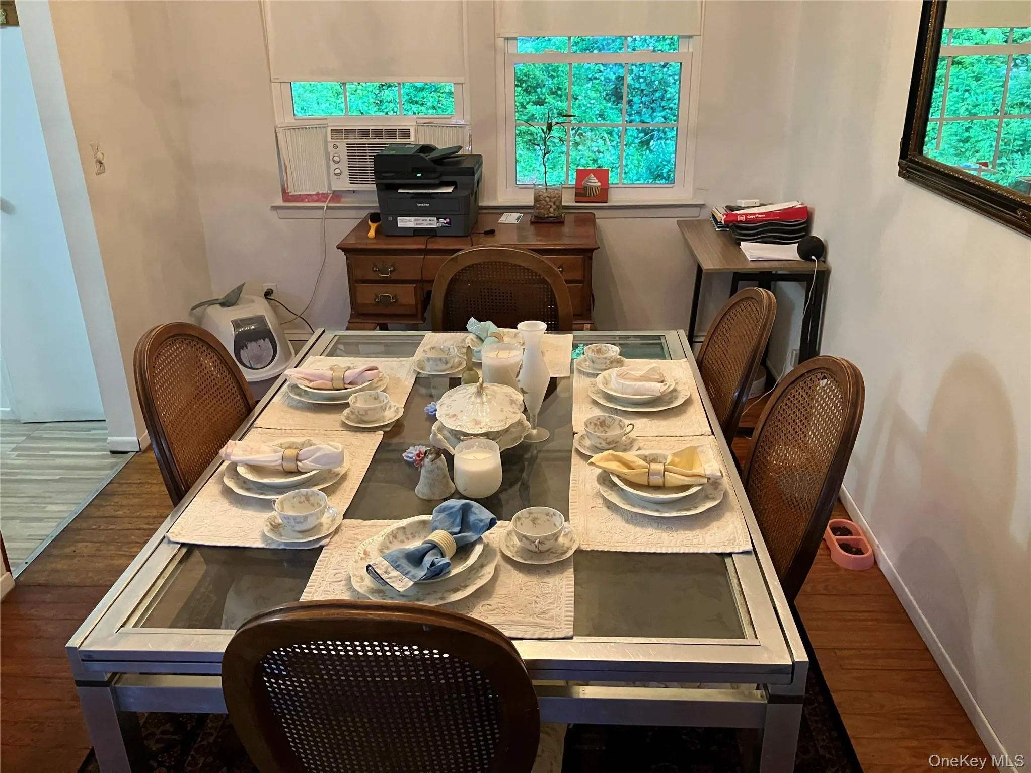 Dining area featuring wood-finish flooring, white painted walls, and window with natural light Dining area featuring wood-finish flooring, white painted walls, and window with natural light