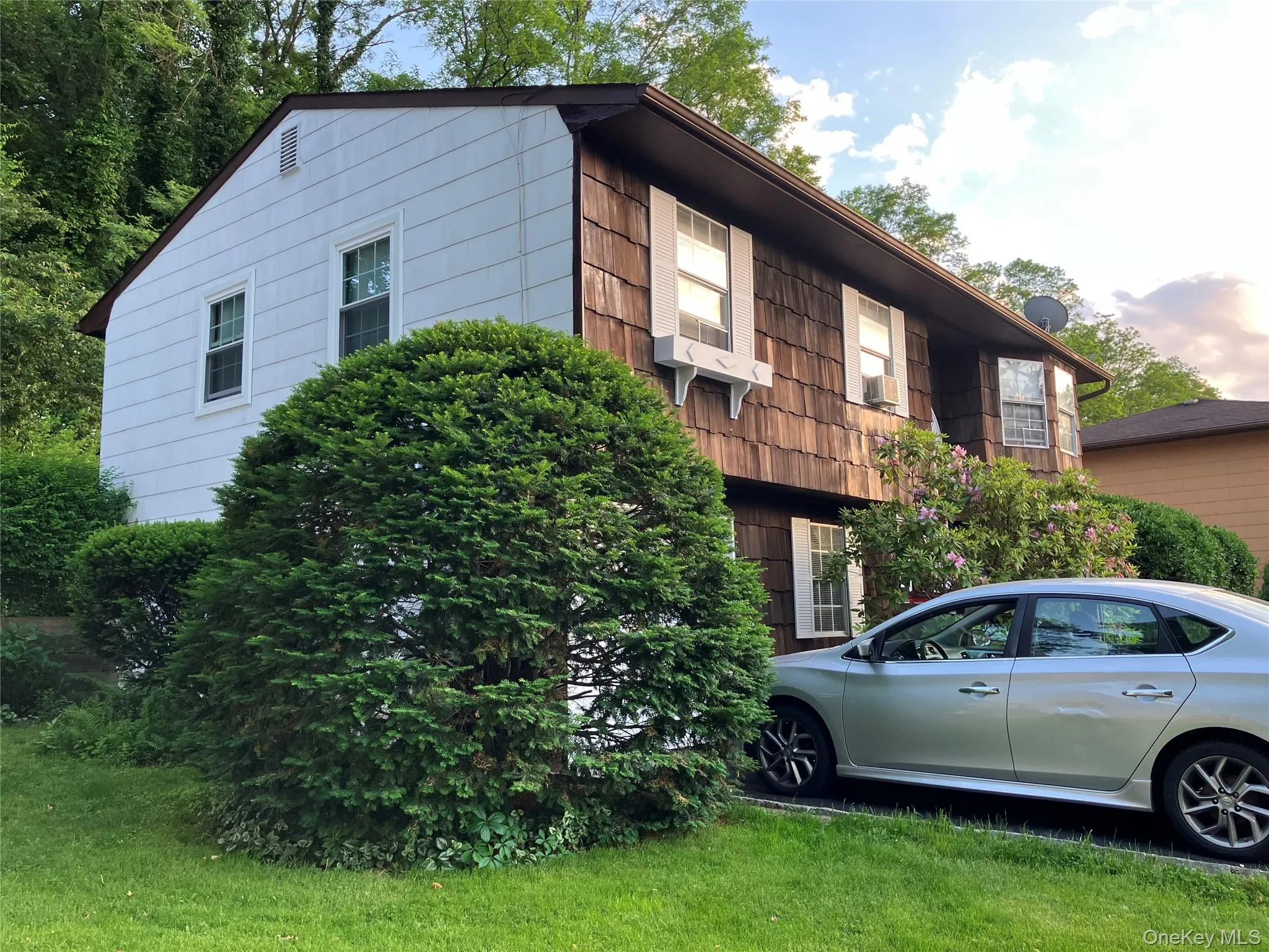 Exterior featuring both wood shake and horizontal siding Exterior featuring both wood shake and horizontal siding