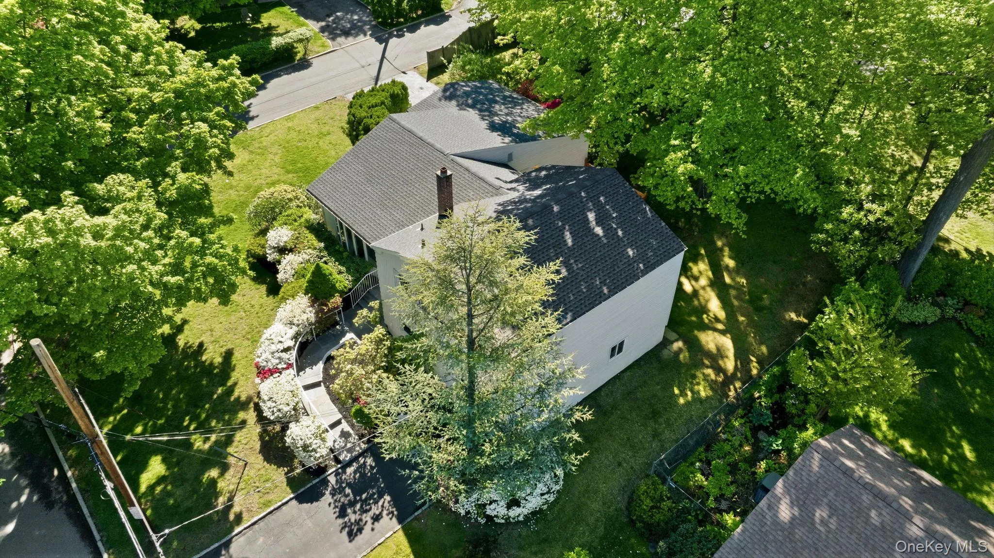 Aerial view of home showing dual driveways and brand-new roof Aerial view of home showing dual driveways and brand-new roof