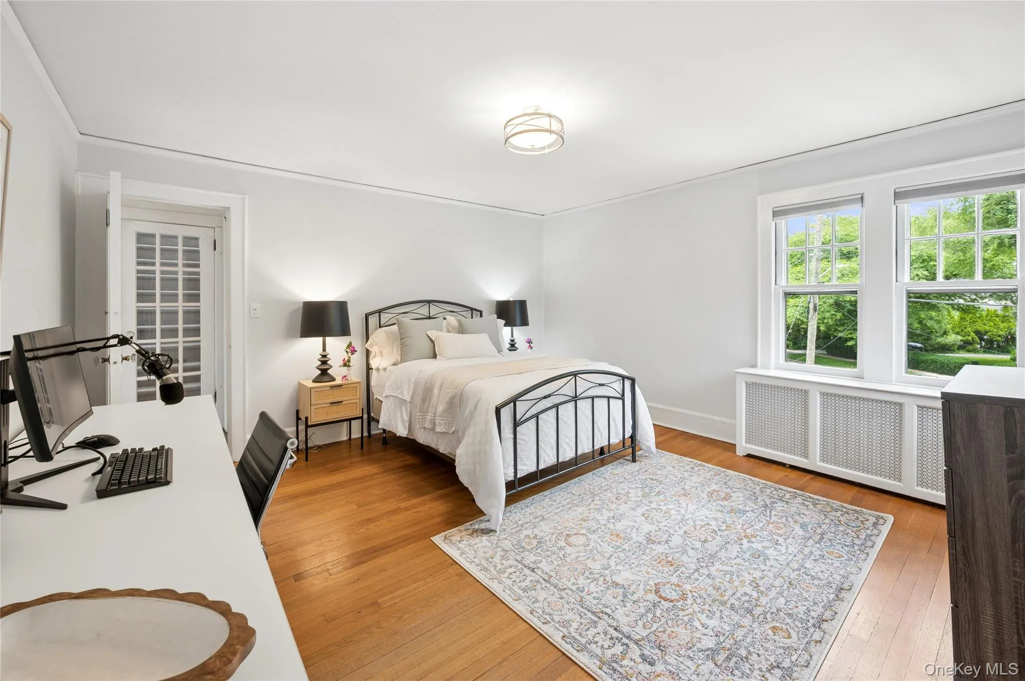 Hardwood flooring, crown molding, and a French door entry Hardwood flooring, crown molding, and a French door entry