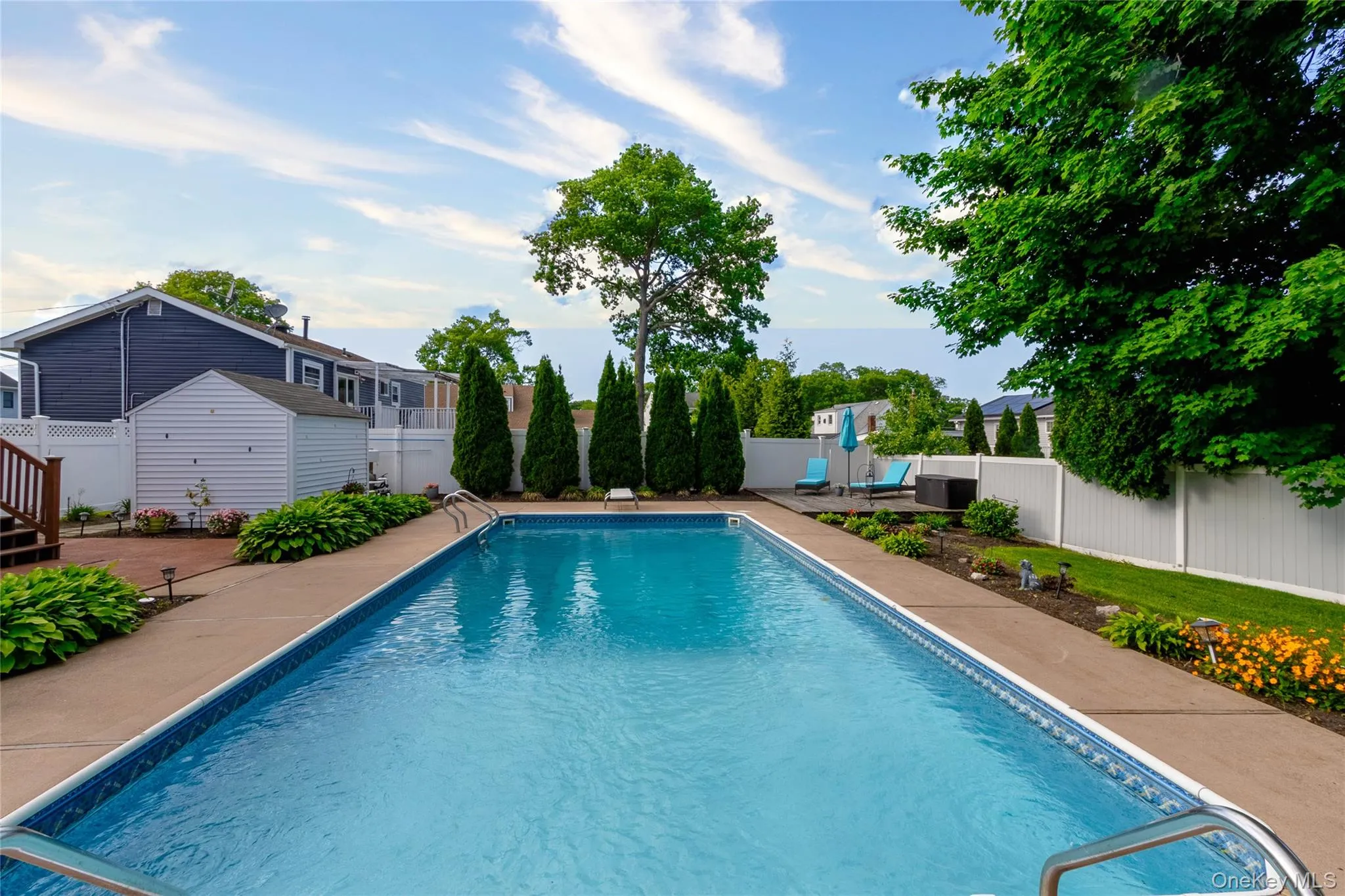 In-ground swimming pool with surrounding concrete decking In-ground swimming pool with surrounding concrete decking