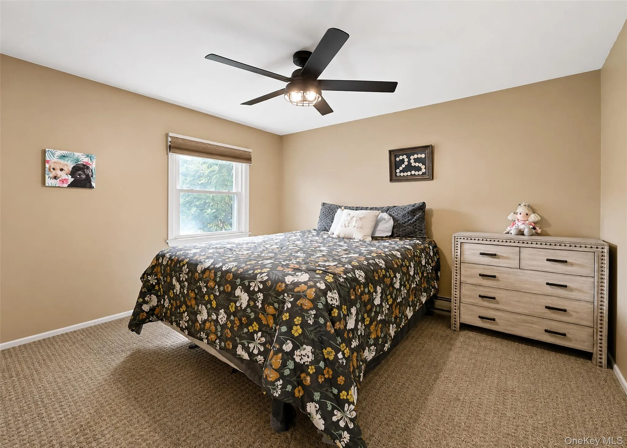Carpeted room featuring a ceiling fan with integrated lighting, a single window with blinds, and light beige wall paint Carpeted room featuring a ceiling fan with integrated lighting, a single window with blinds, and light beige wall paint