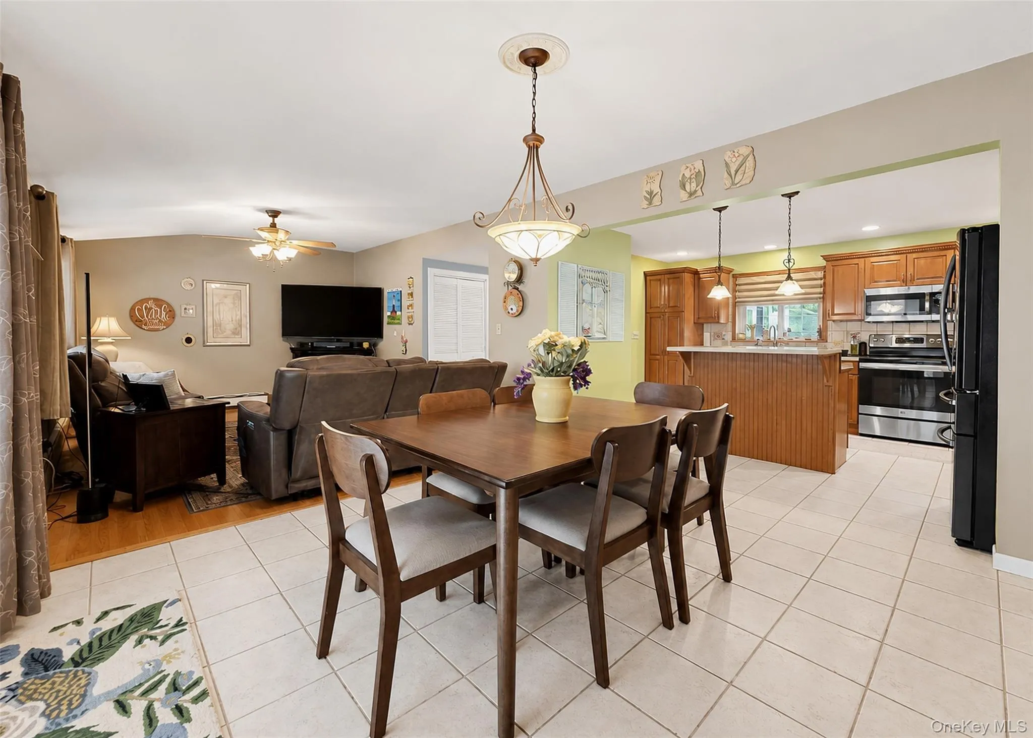 Open-concept living space with a dining area, kitchen, and living room Open-concept living space with a dining area, kitchen, and living room