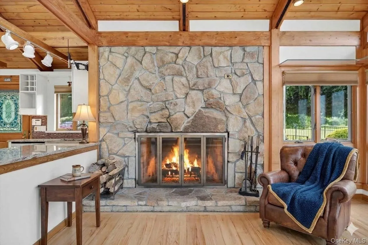 Rustic woodburning stone fireplace keeps the home warm and cozy on chilly winter days*virtually staged* Rustic woodburning stone fireplace keeps the home warm and cozy on chilly winter days*virtually staged*