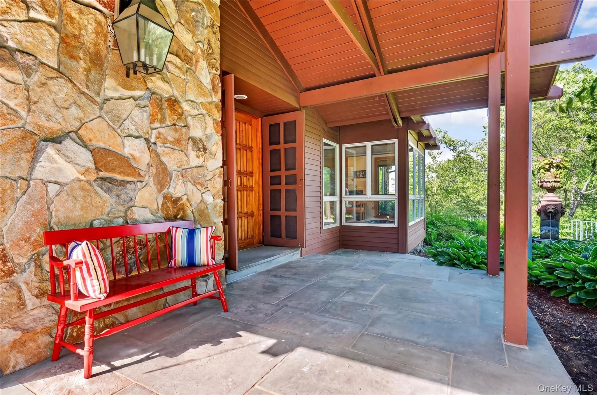 Wood, slate and stone entrance contribute to the rustic vibe Wood, slate and stone entrance contribute to the rustic vibe