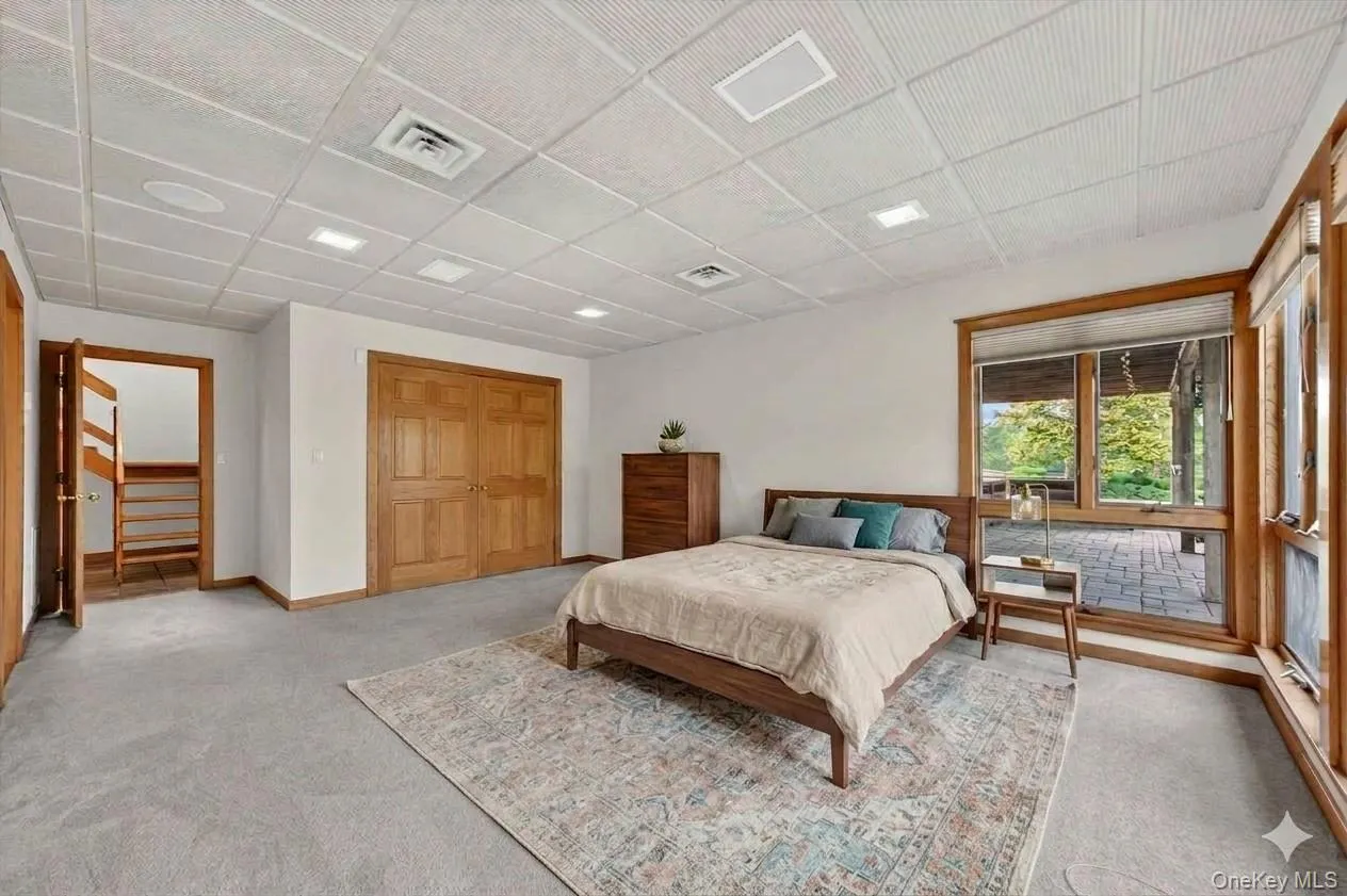 One of two bedrooms on the lower level with direct access to the pool deck*virtually staged* One of two bedrooms on the lower level with direct access to the pool deck*virtually staged*