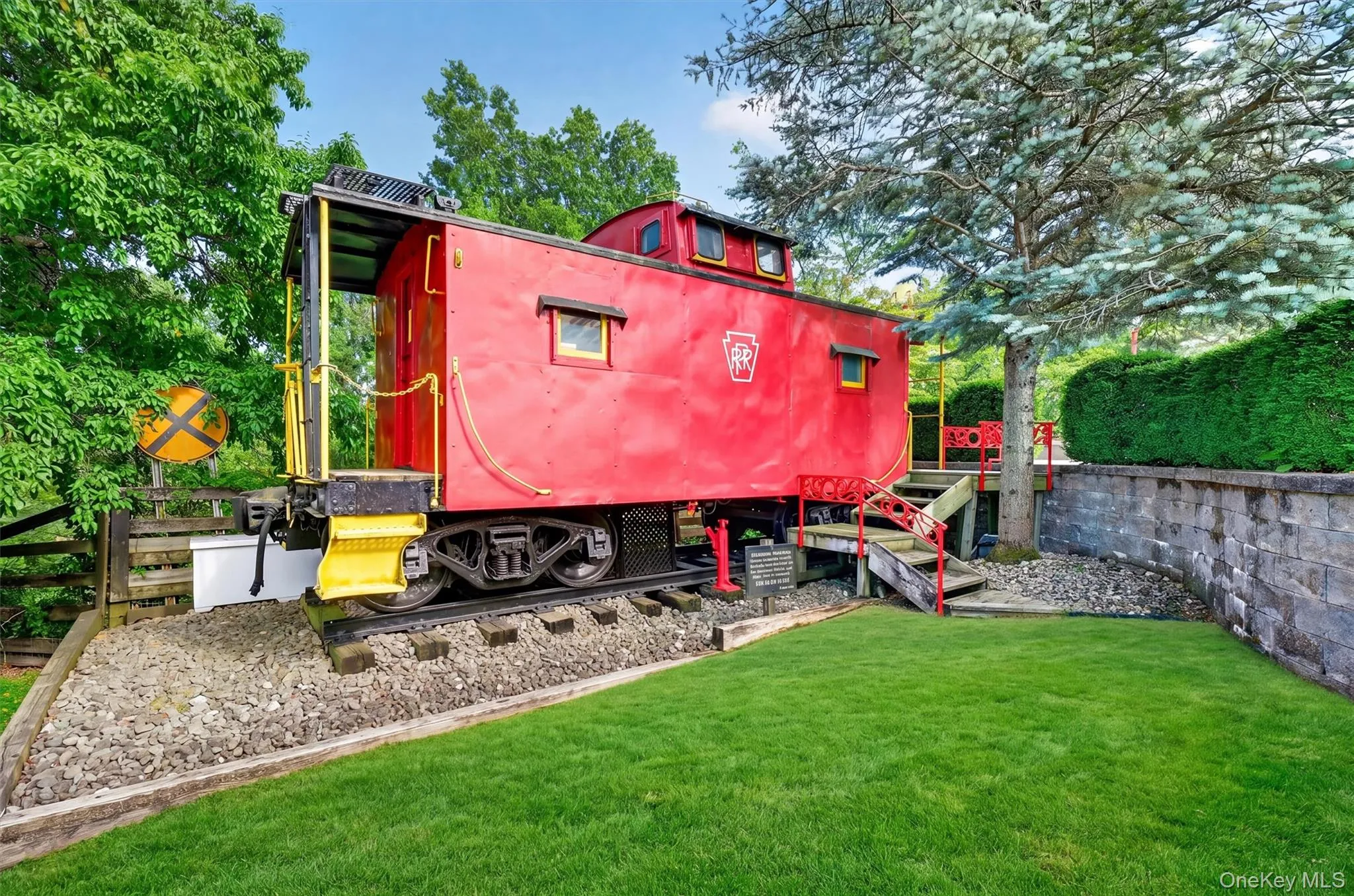 A genuine caboose from the Eastern shore of Virginia sits just below the pool deck and serves as a very cool pool house with seating and a kitchenette A genuine caboose from the Eastern shore of Virginia sits just below the pool deck and serves as a very cool pool house with seating and a kitchenette