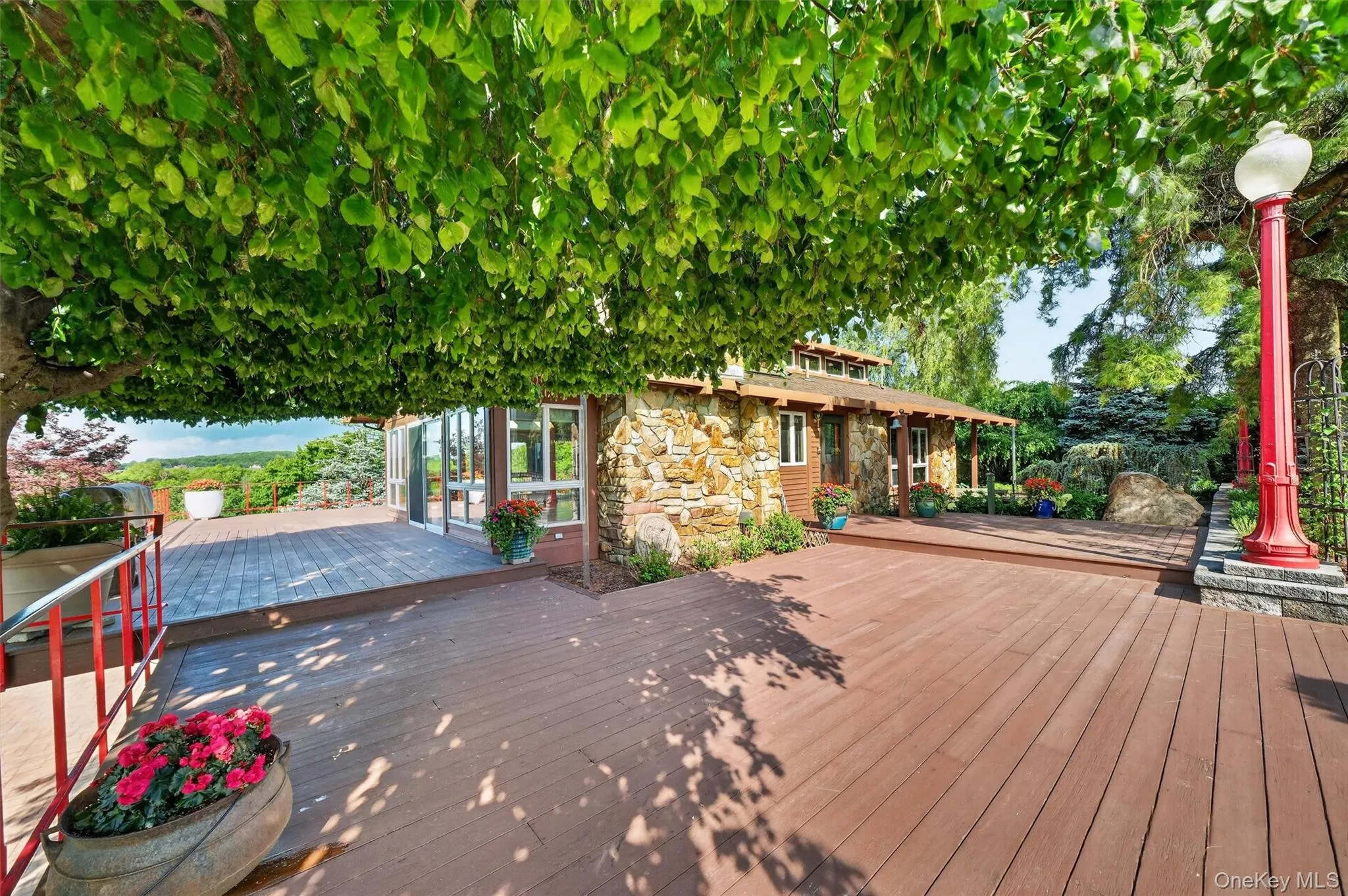 The side deck is canopied by a wonderful weeping birch tree, providing shade and an artistic backdrop The side deck is canopied by a wonderful weeping birch tree, providing shade and an artistic backdrop
