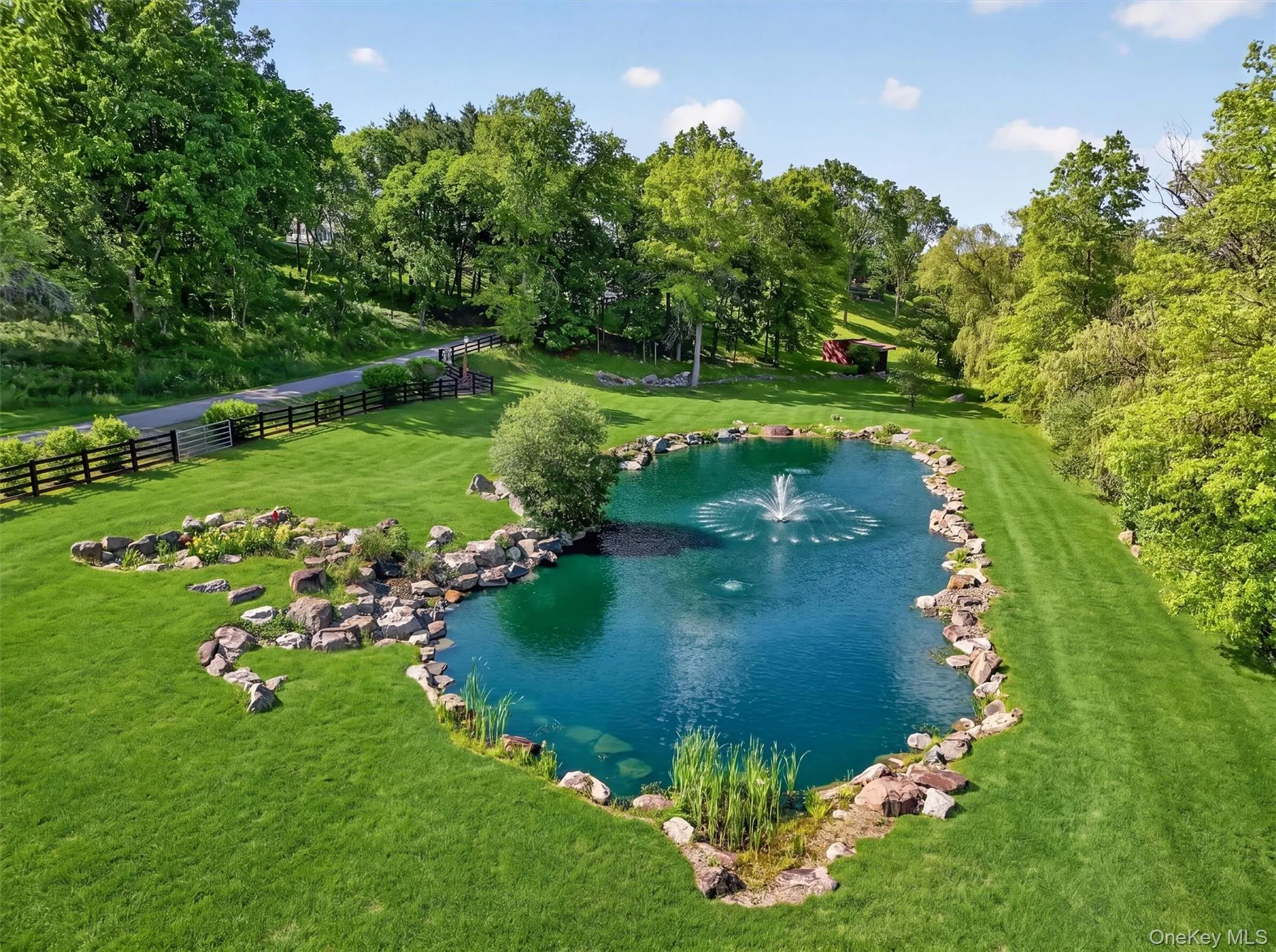 The largest of 3 koi ponds creates a park like feeling as you enter the property The largest of 3 koi ponds creates a park like feeling as you enter the property
