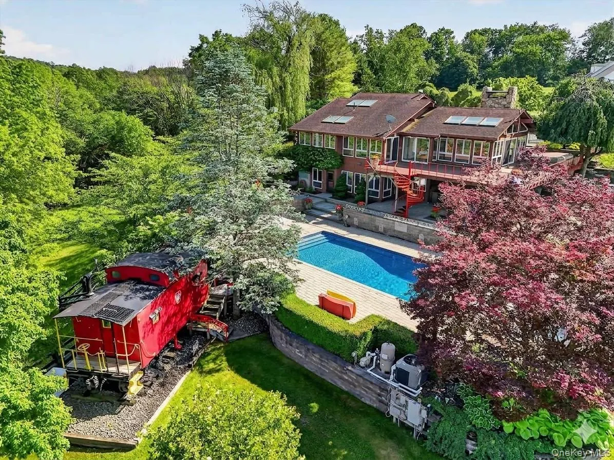 The expansive pool deck features a salt water pool, koi pond, hot tub, fire pit, outdoor cook area and a caboose! The expansive pool deck features a salt water pool, koi pond, hot tub, fire pit, outdoor cook area and a caboose!