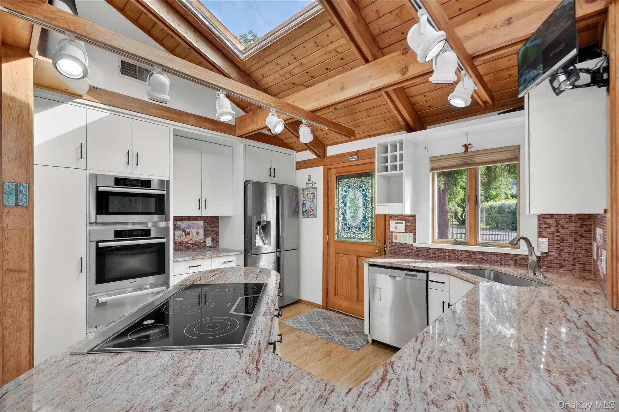 Backdoor guests are best! Friends and family will enter through the open concept kitchen which features top tier appliances and skylights Backdoor guests are best! Friends and family will enter through the open concept kitchen which features top tier appliances and skylights