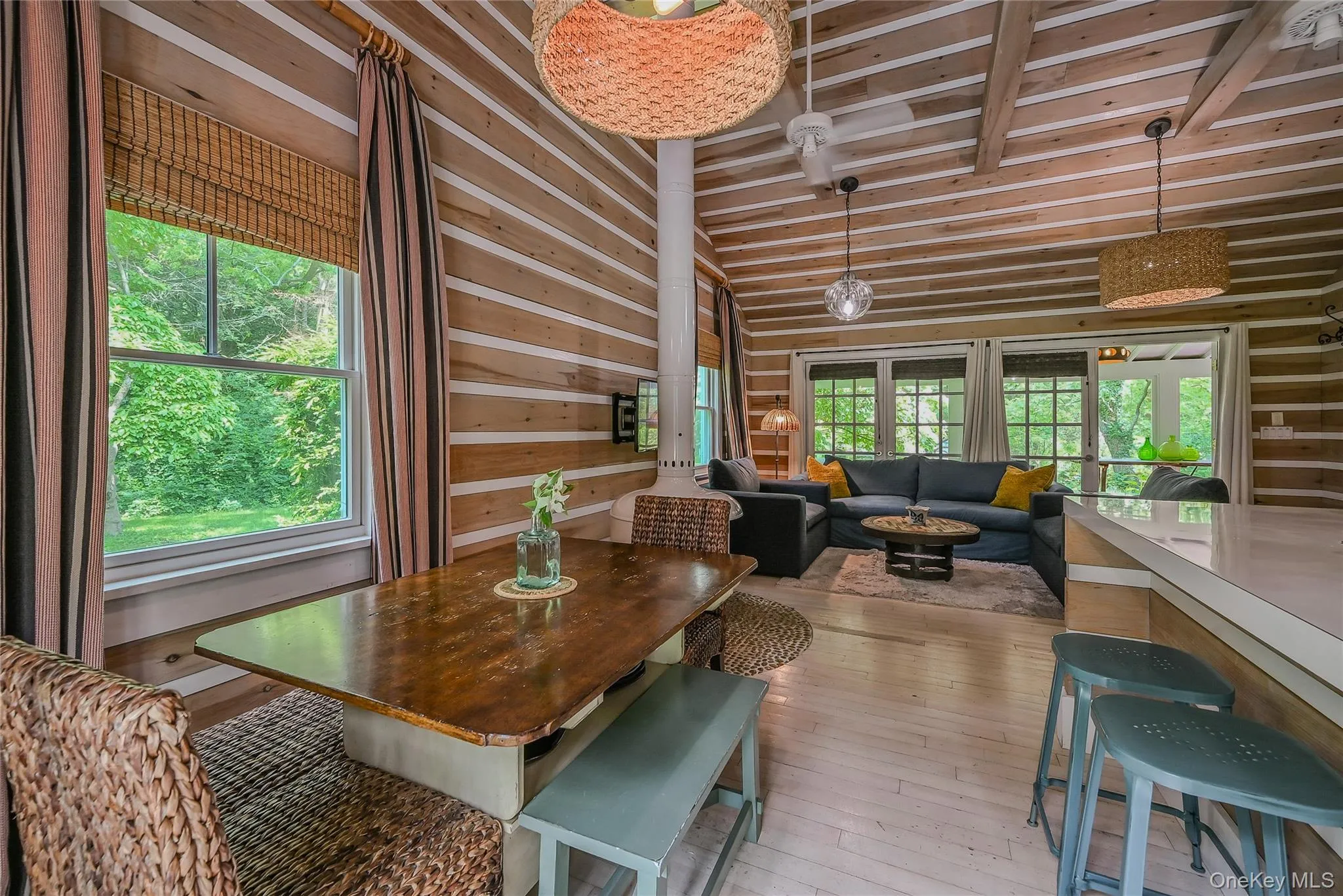 Dining room with light wood-type flooring and wood ceiling Dining room with light wood-type flooring and wood ceiling