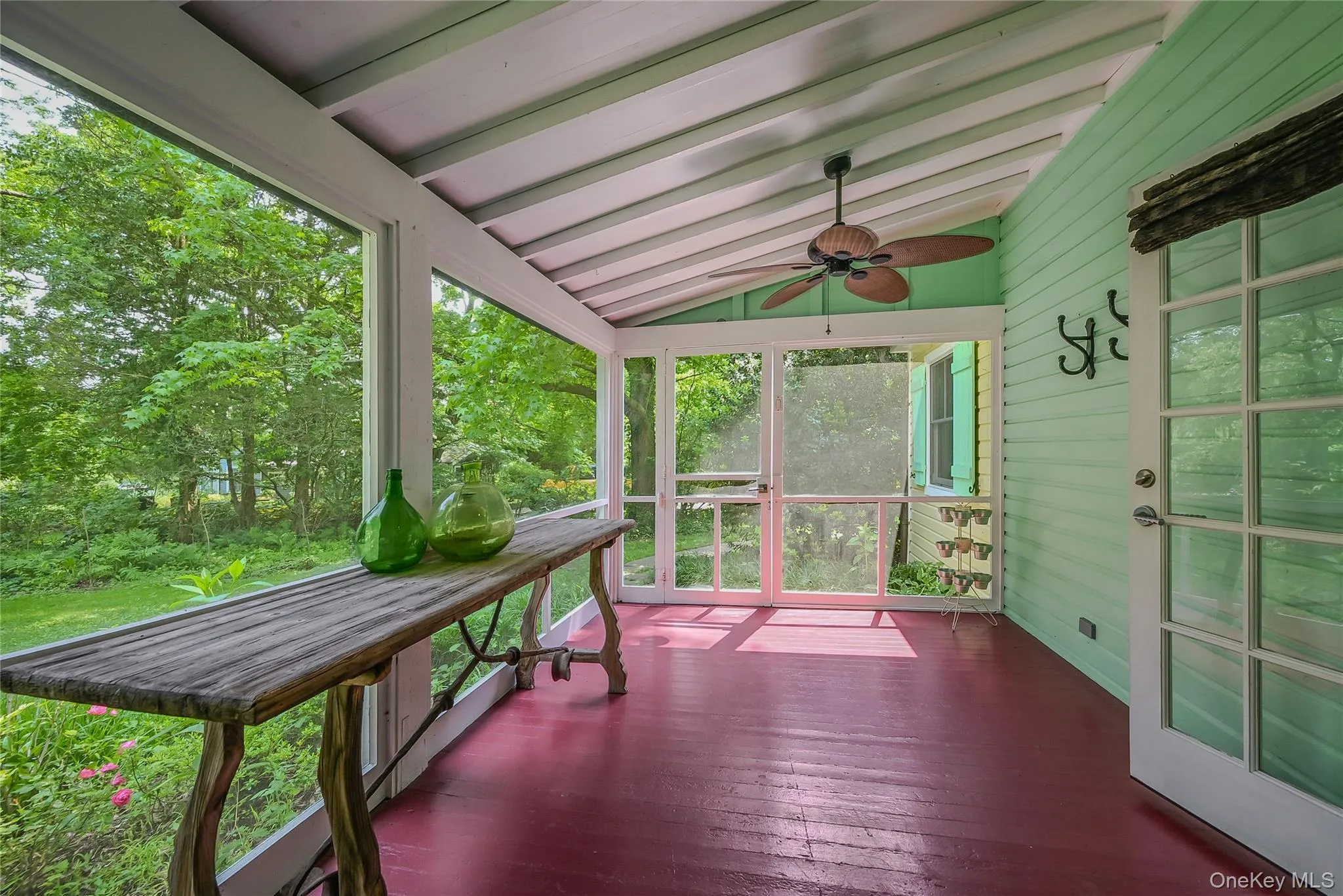 Sunroom featuring a ceiling fan and healthy amount of natural light Sunroom featuring a ceiling fan and healthy amount of natural light