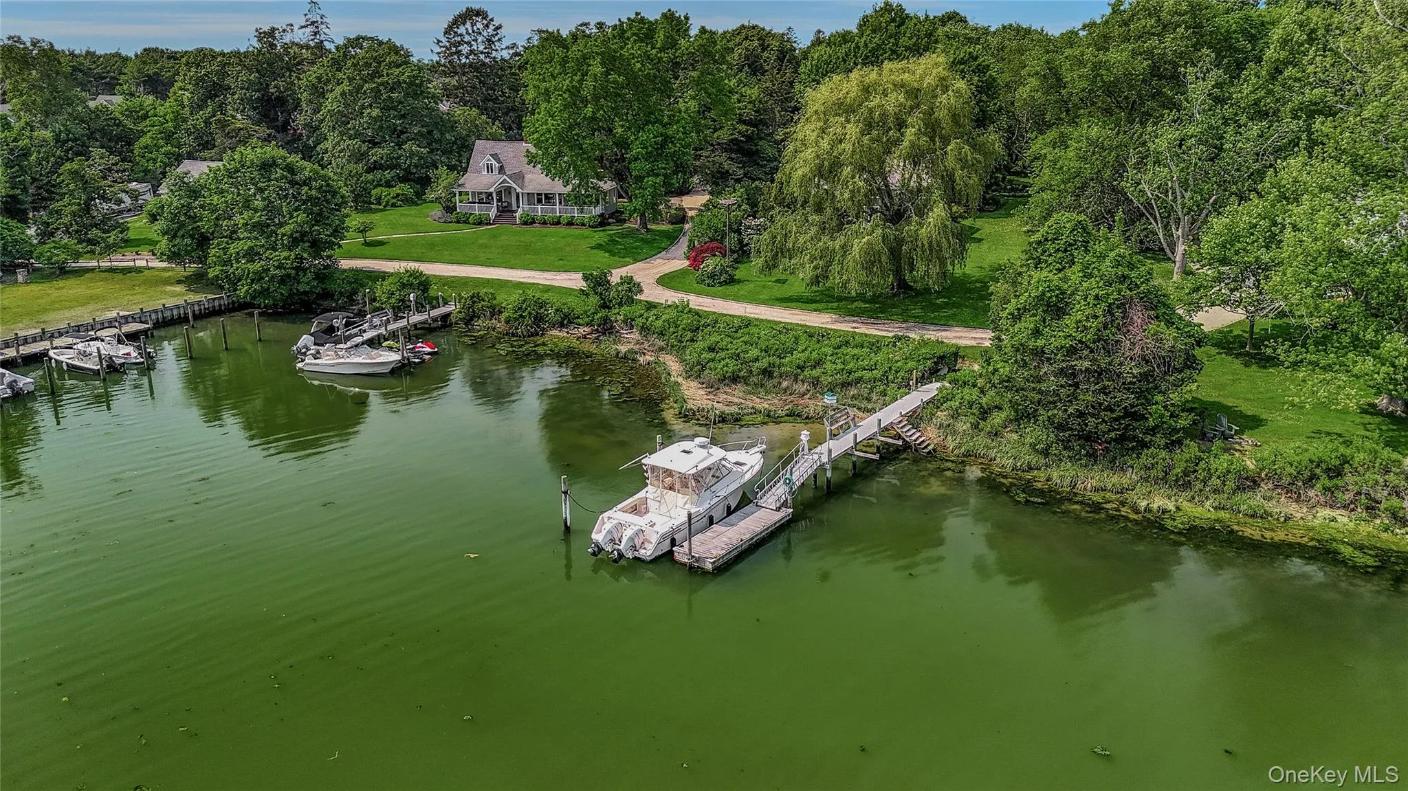 Aerial view of property and surrounding area with a nearby body of water Aerial view of property and surrounding area with a nearby body of water