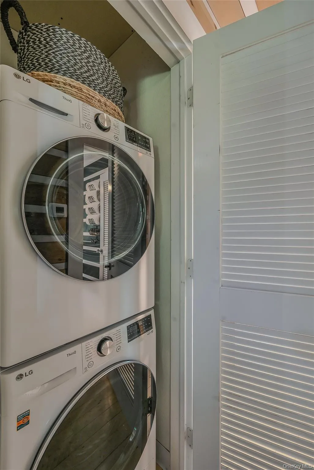 Laundry room with stacked washing machine and dryer Laundry room with stacked washing machine and dryer