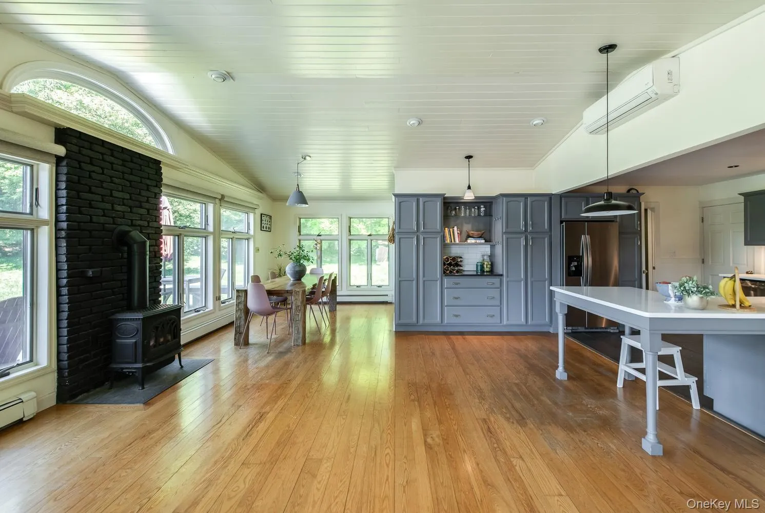Open concept family room, breakfast bar, and dining area with hardwood floors Open concept family room, breakfast bar, and dining area with hardwood floors