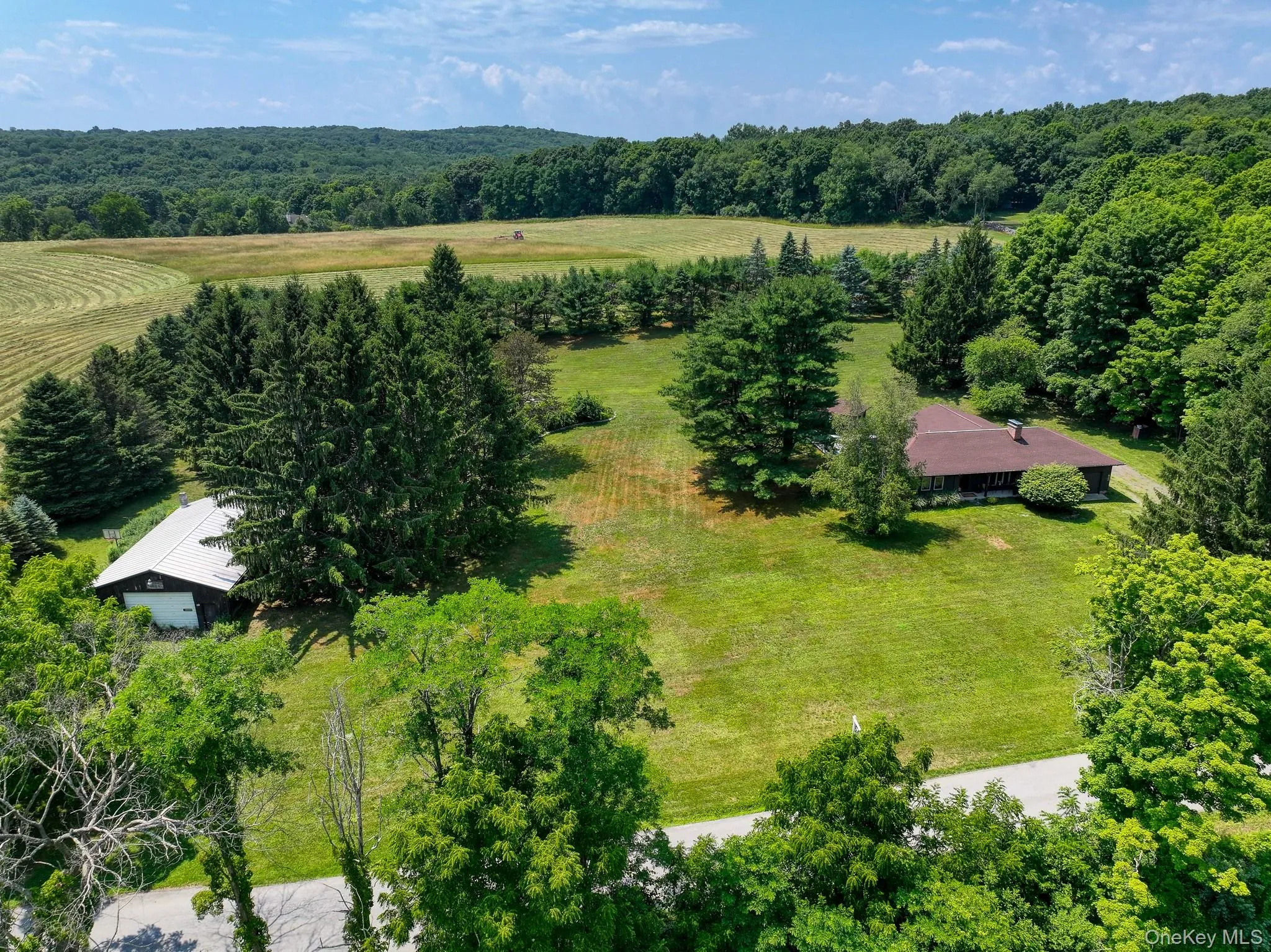 Aerial view of the entire 2.6 acres surrounded by a tree line for additional privacy Aerial view of the entire 2.6 acres surrounded by a tree line for additional privacy