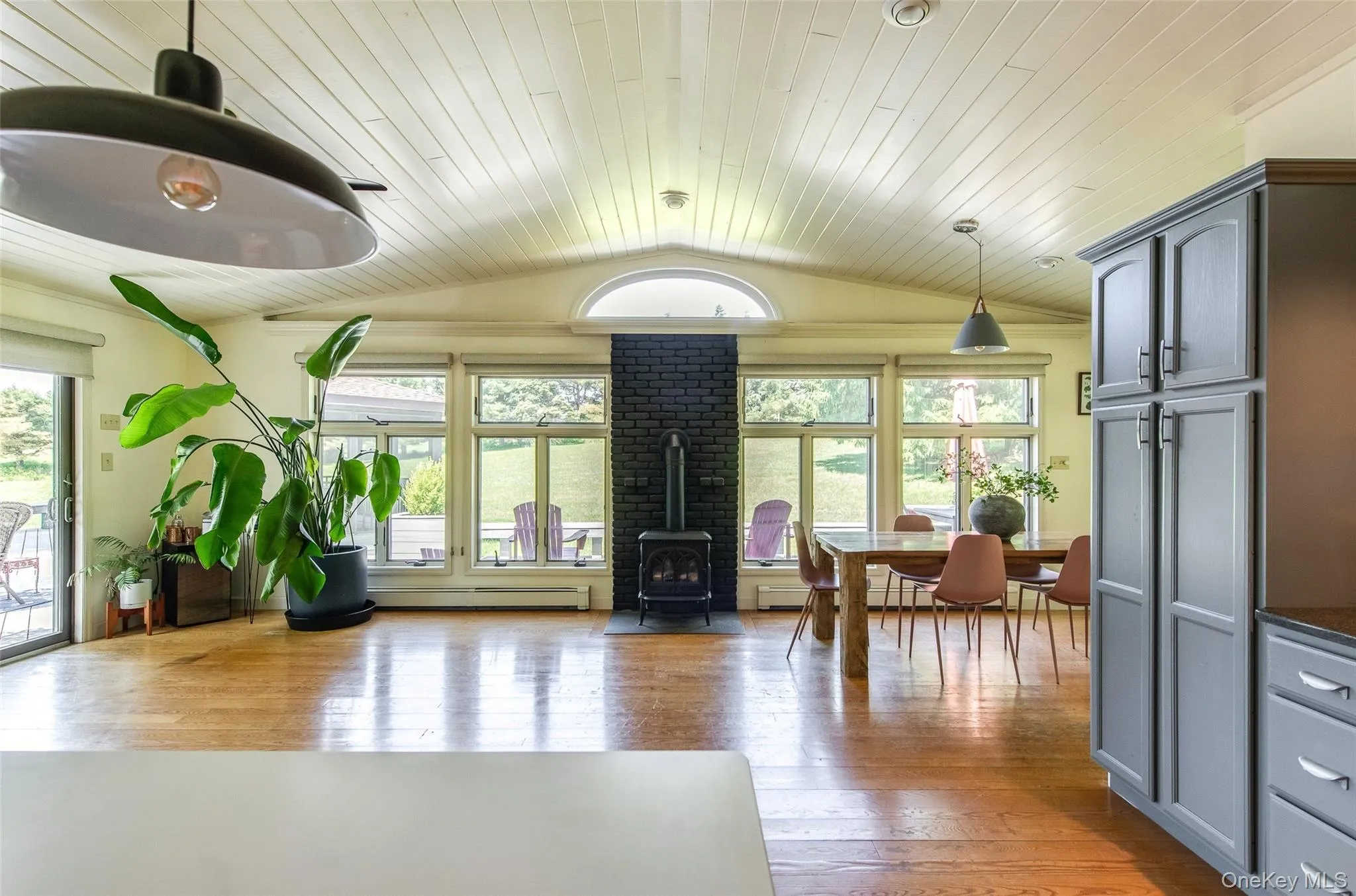 From kitchen into family room with gas burning stove and a wall of windows to enjoy your beautiful property year round From kitchen into family room with gas burning stove and a wall of windows to enjoy your beautiful property year round