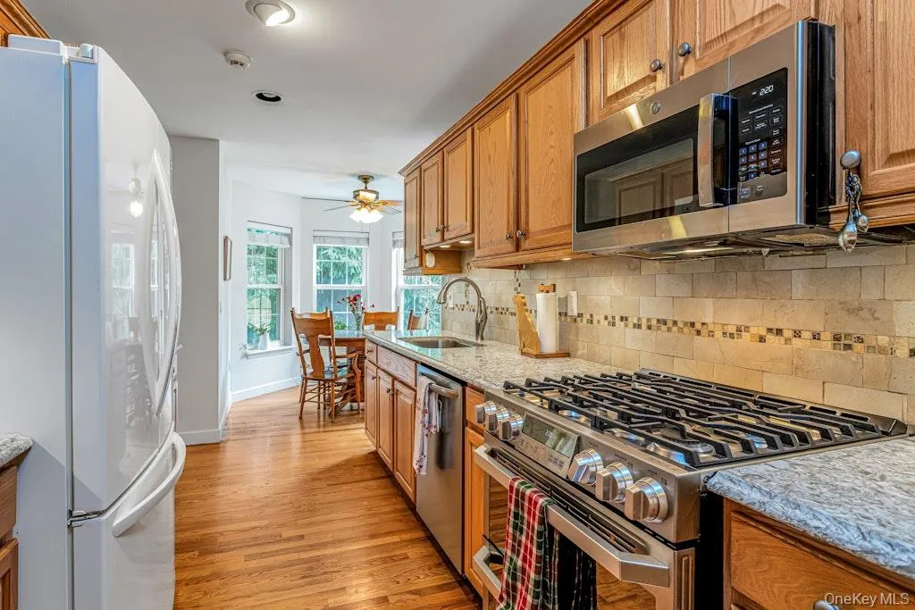 Looking in the other direction of the kitchen you can see the bay windows surrounding the charming breakfast nook. What a lovely spot to have your coffee first thing in the morning, or tea, if tea is what you love. Looking in the other direction of the kitchen you can see the bay windows surrounding the charming breakfast nook. What a lovely spot to have your coffee first thing in the morning, or tea, if tea is what you love.
