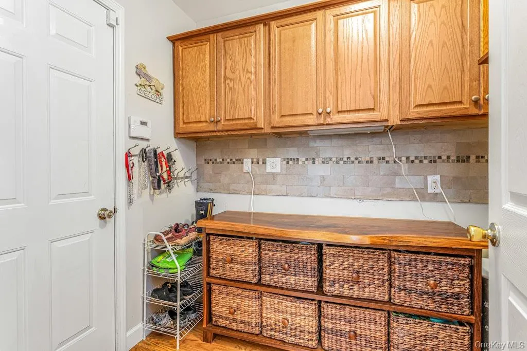 Going back through the kitchen and into the pantry you have built-in cabinets on the wall, a tile backsplash, and the door leading to the spacious 2-car garage which is, by the way outfitted with an EV Charger. Going back through the kitchen and into the pantry you have built-in cabinets on the wall, a tile backsplash, and the door leading to the spacious 2-car garage which is, by the way outfitted with an EV Charger.