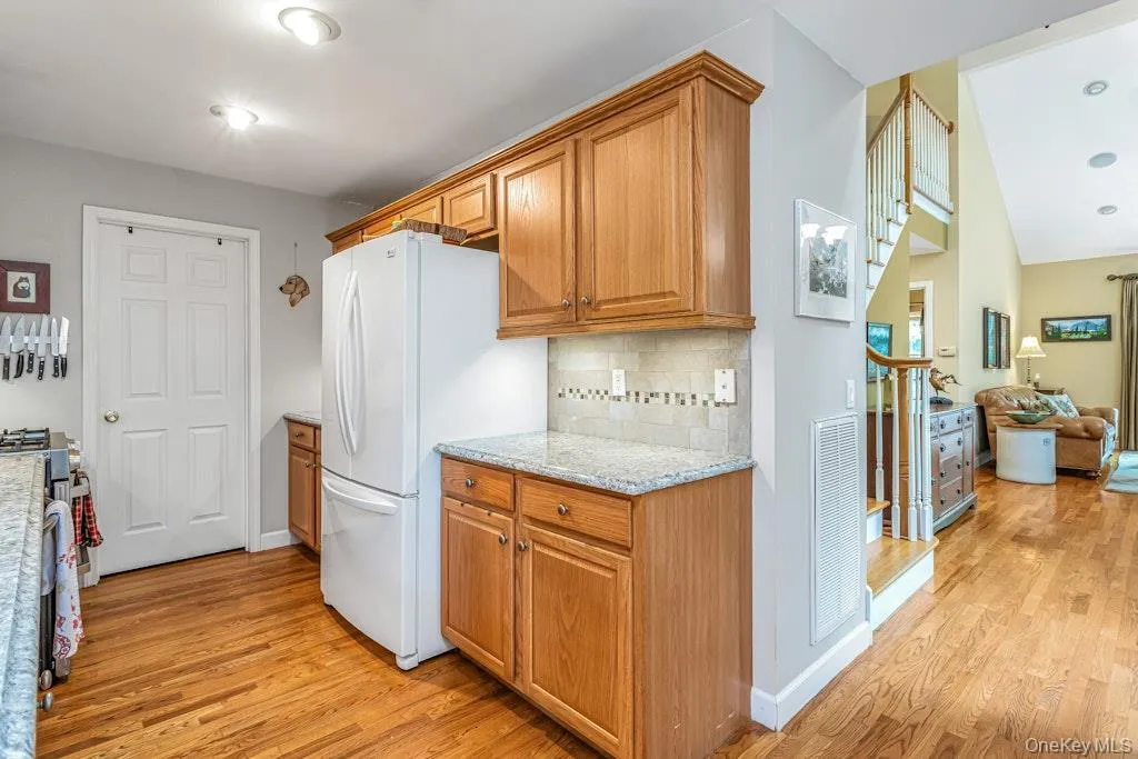 On the opposite side of the kitchen there’s additional cabinetry and counter space, quartz, in case you're wondering and a large refrigerator with the freezer on the bottom. On the opposite side of the kitchen there’s additional cabinetry and counter space, quartz, in case you're wondering and a large refrigerator with the freezer on the bottom.